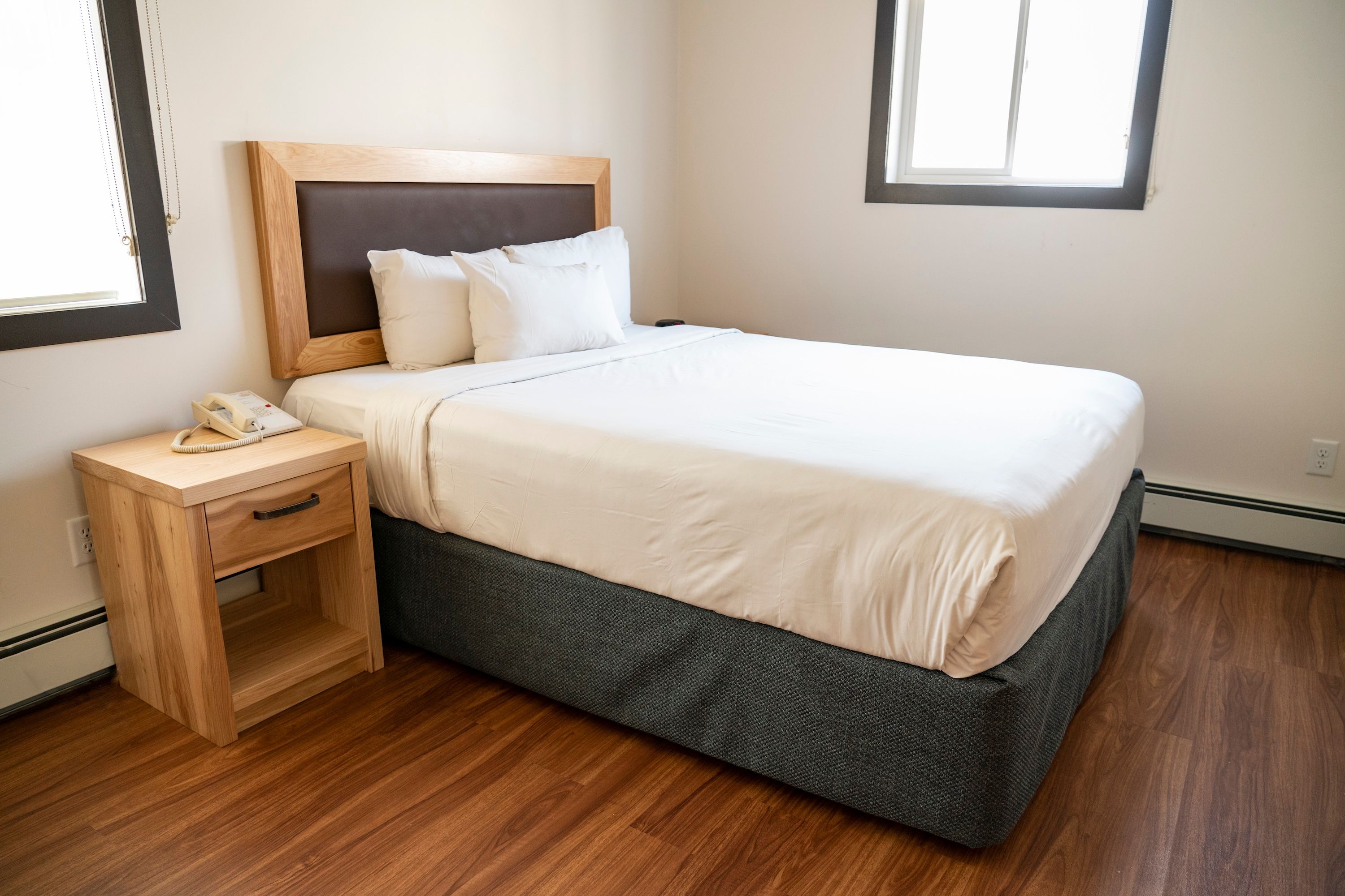 image Enjoy a restful night in the queen bed, with warm wooden accents and natural light streaming in