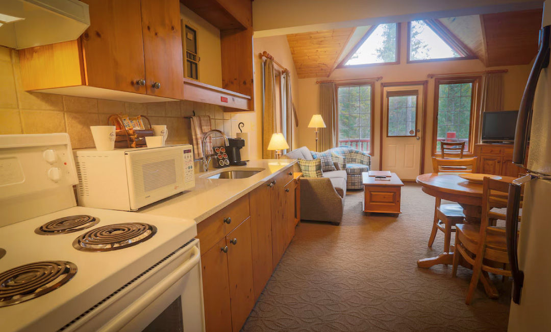 image Cook up a storm in the fully-equipped kitchen, with modern appliances and inviting wooden cabinetry.