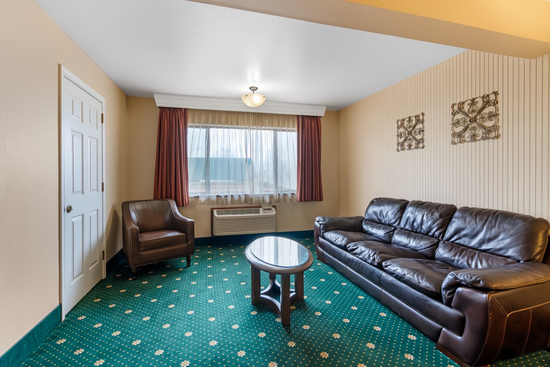 image Reading chair and wet bar in the king room — cold drinks within reach after a day of travel.