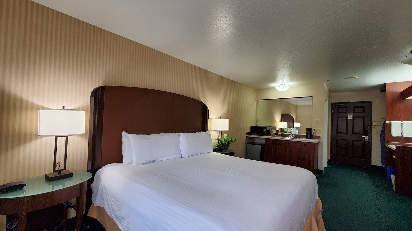 image King bed paired with an ergonomic work desk and reading chair for business or leisure.