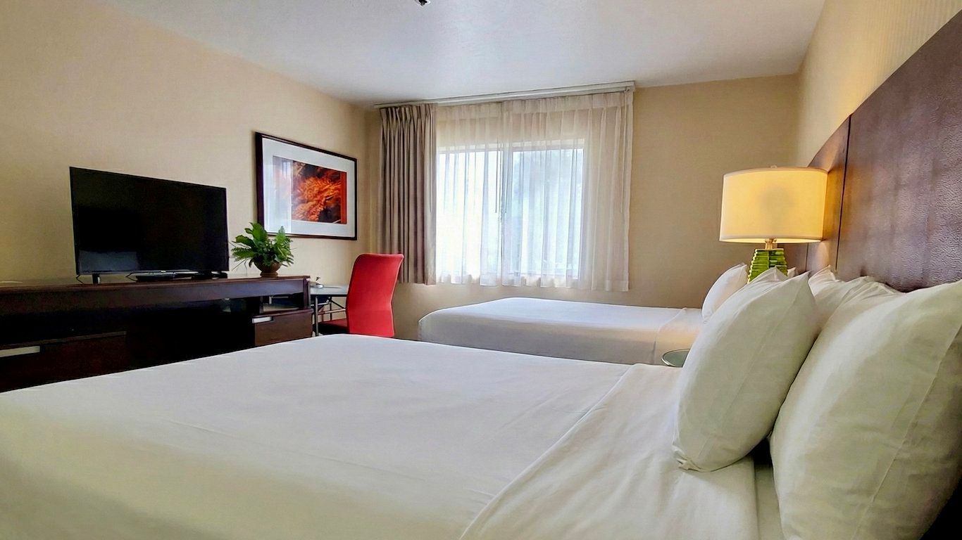 image Two queen beds, LCD TV, and comfortable seating — all you need for a solid night in.