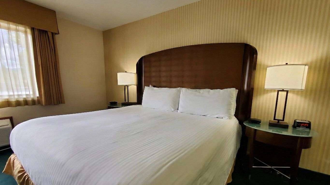 image Natural light fills the room, with a comfortable king bed and open layout.
