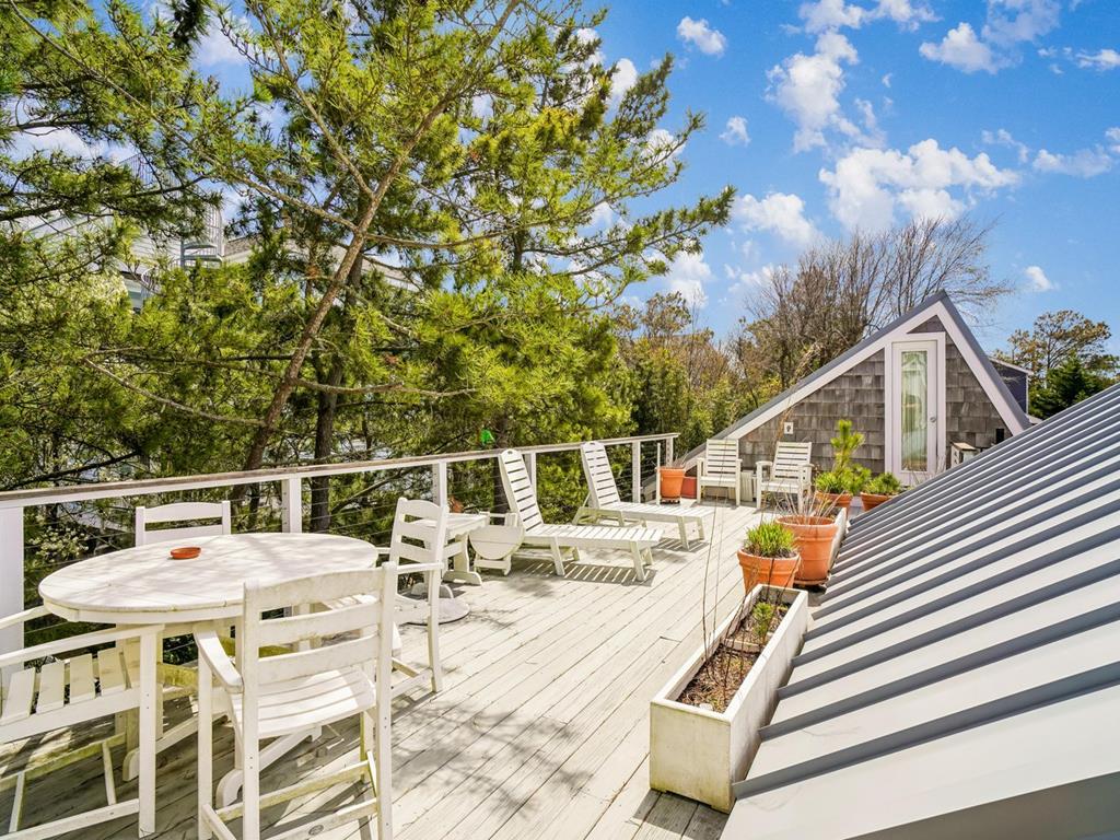 image Upper deck with tables, chairs, and sun loungers — catch the ocean breeze from the top level