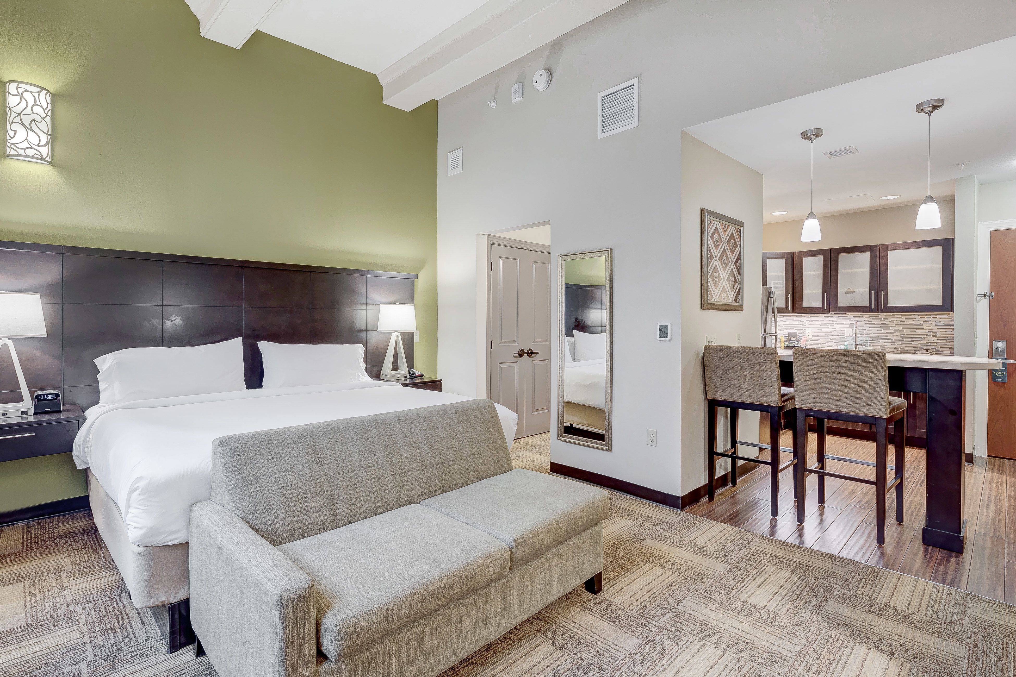 image Cozy suite featuring a plush bed and modern decor elements.