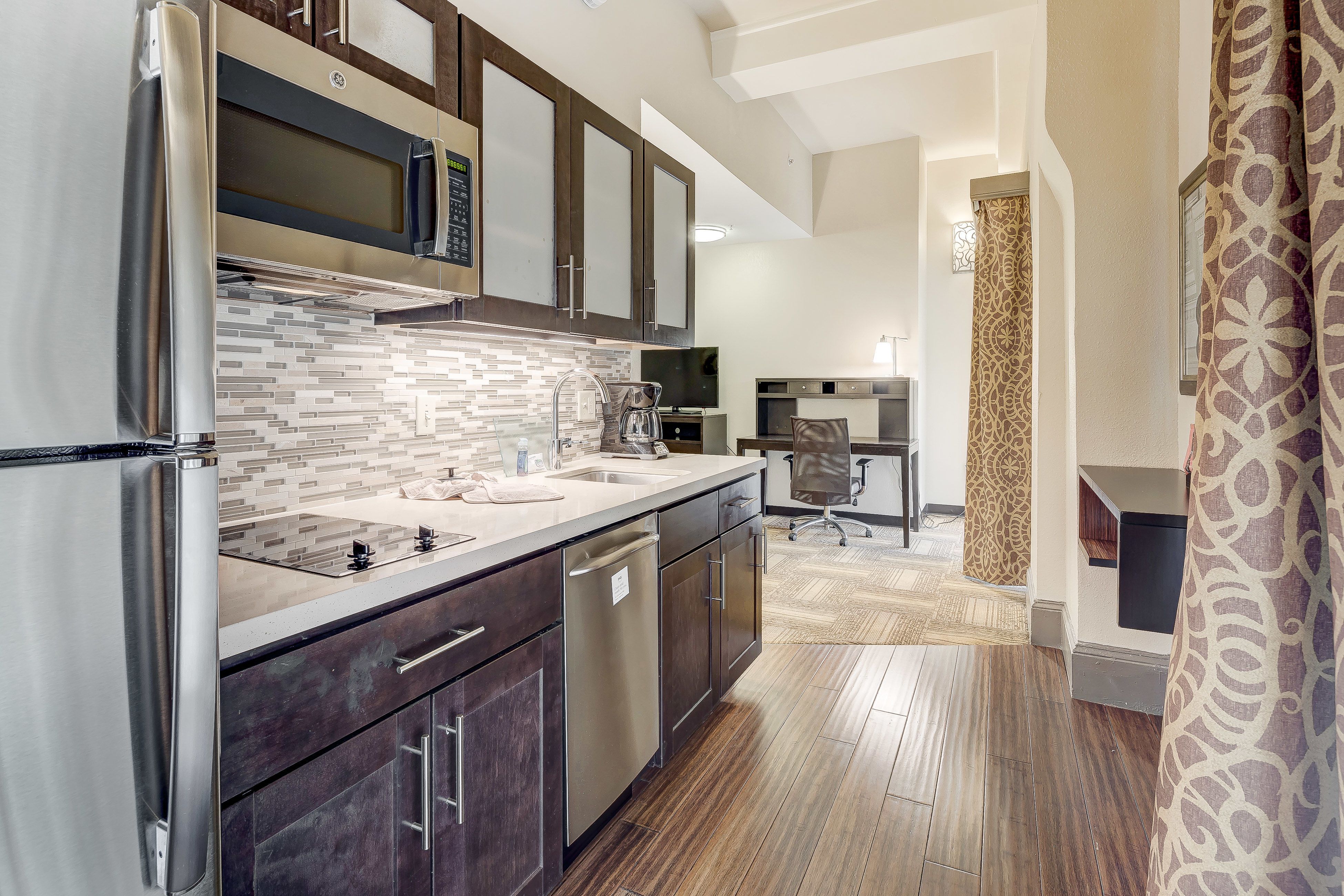 image Functional kitchen with stainless steel appliances and stylish finishes.