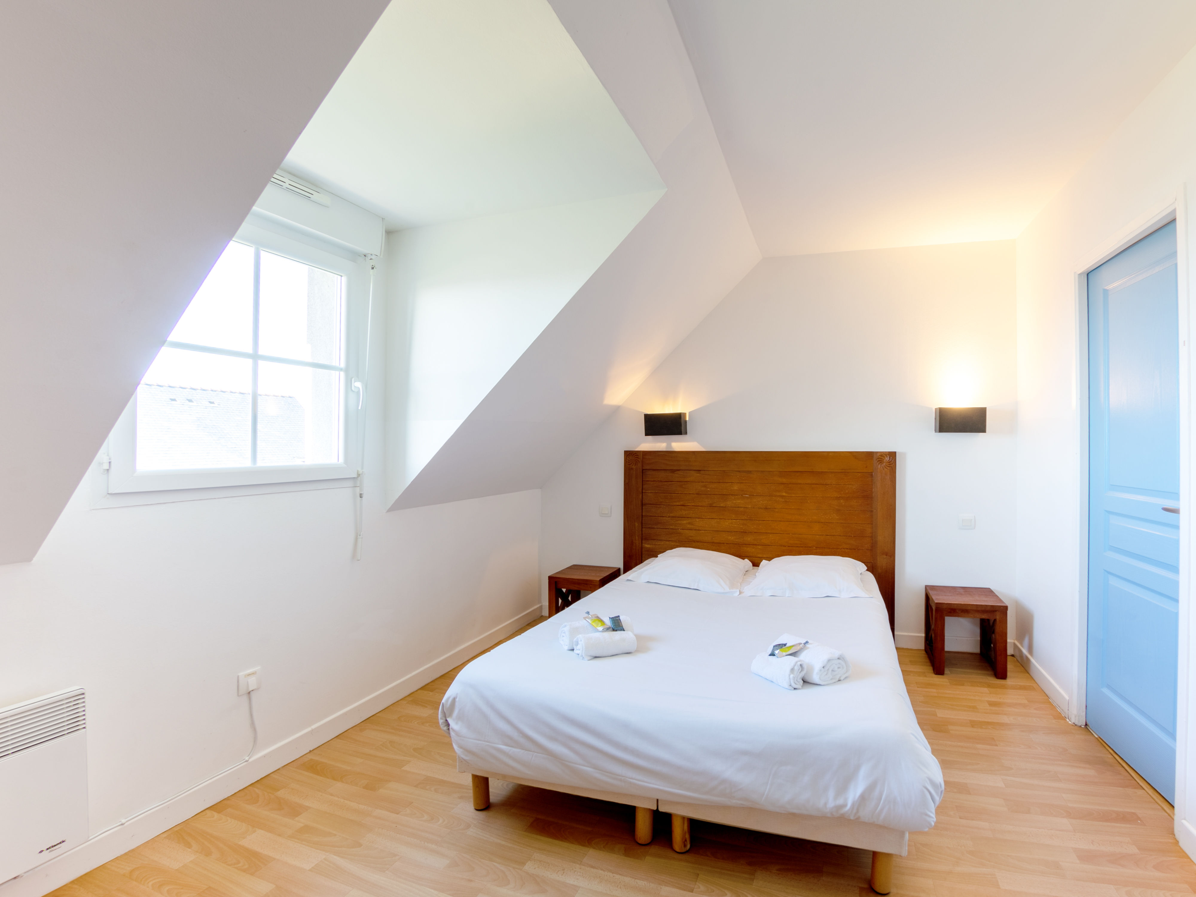 image Double bed with white linens — wake up and step straight onto the private terrace overlooking the bay