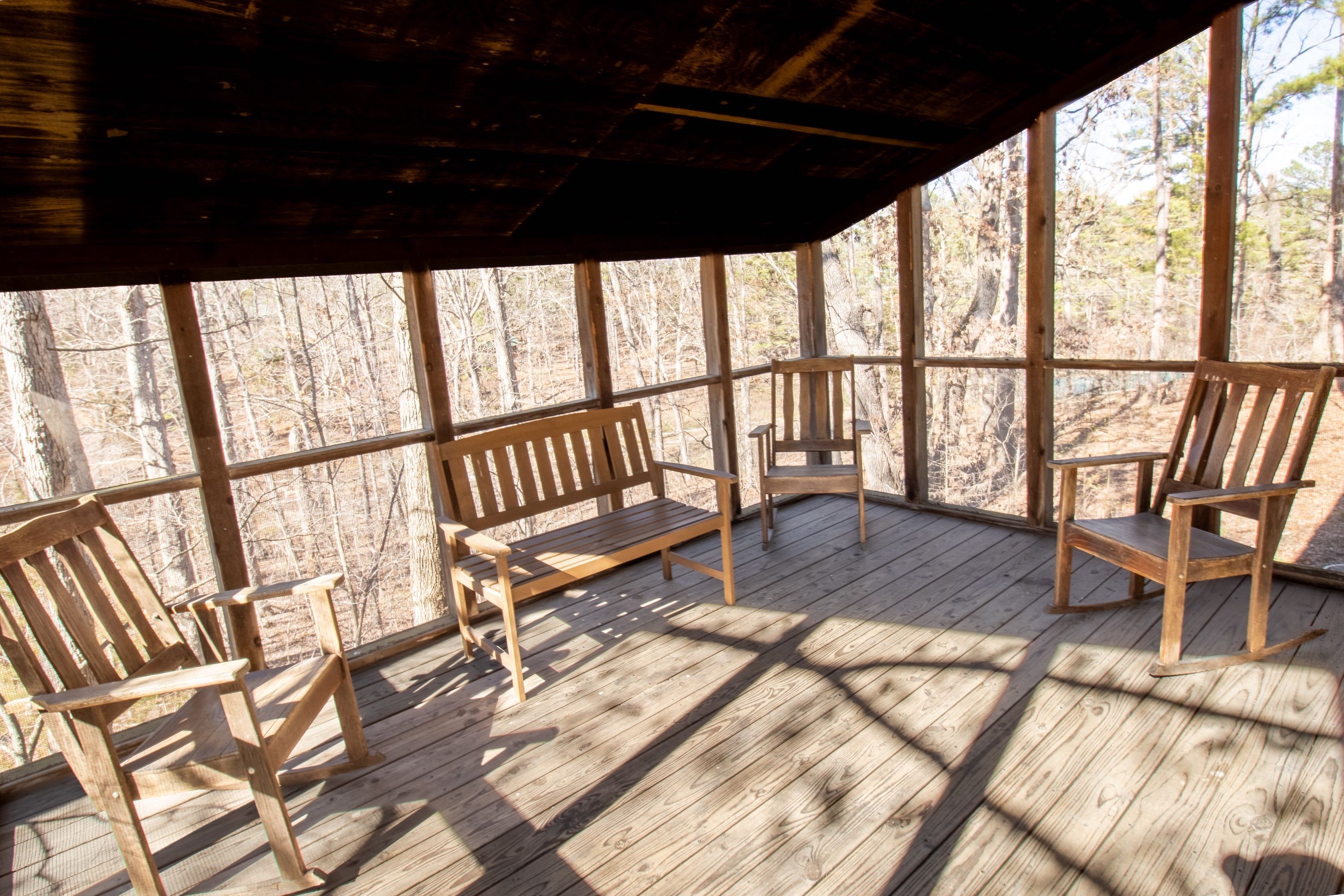 image Unwind on the screened porch, sipping coffee while surrounded by peaceful forest views.