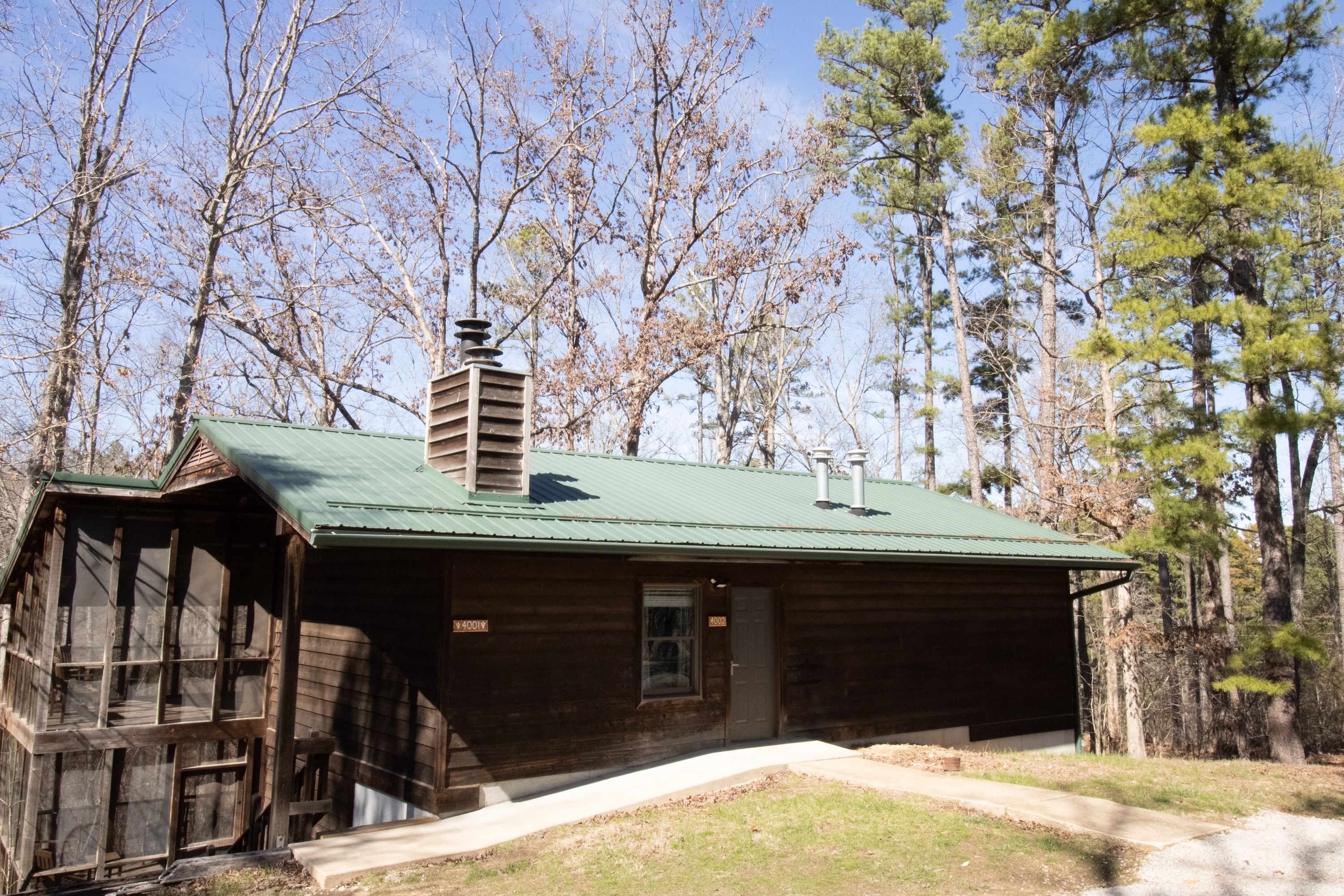 image Nestled among tall trees, this cabin invites you to enjoy nature just steps away.