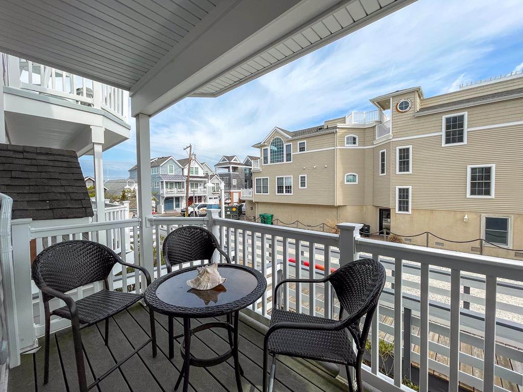 image Covered balcony with bistro table and two chairs — your private spot for morning coffee or an evening drink overlooking the Marina District.