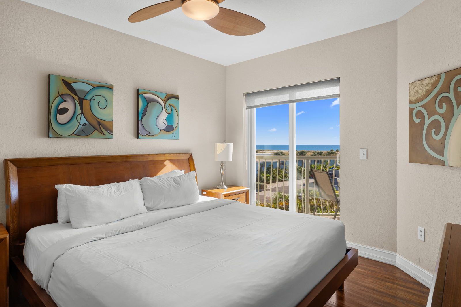 image Wake up in the king-bed room with soft white linens, a TV, and direct access to the private balcony.