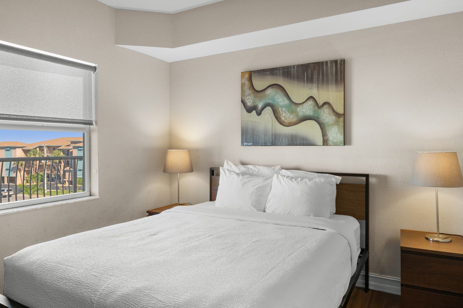 image The queen bedroom features vibrant artwork, a wall-mounted TV, and air conditioning for a cool night's sleep.