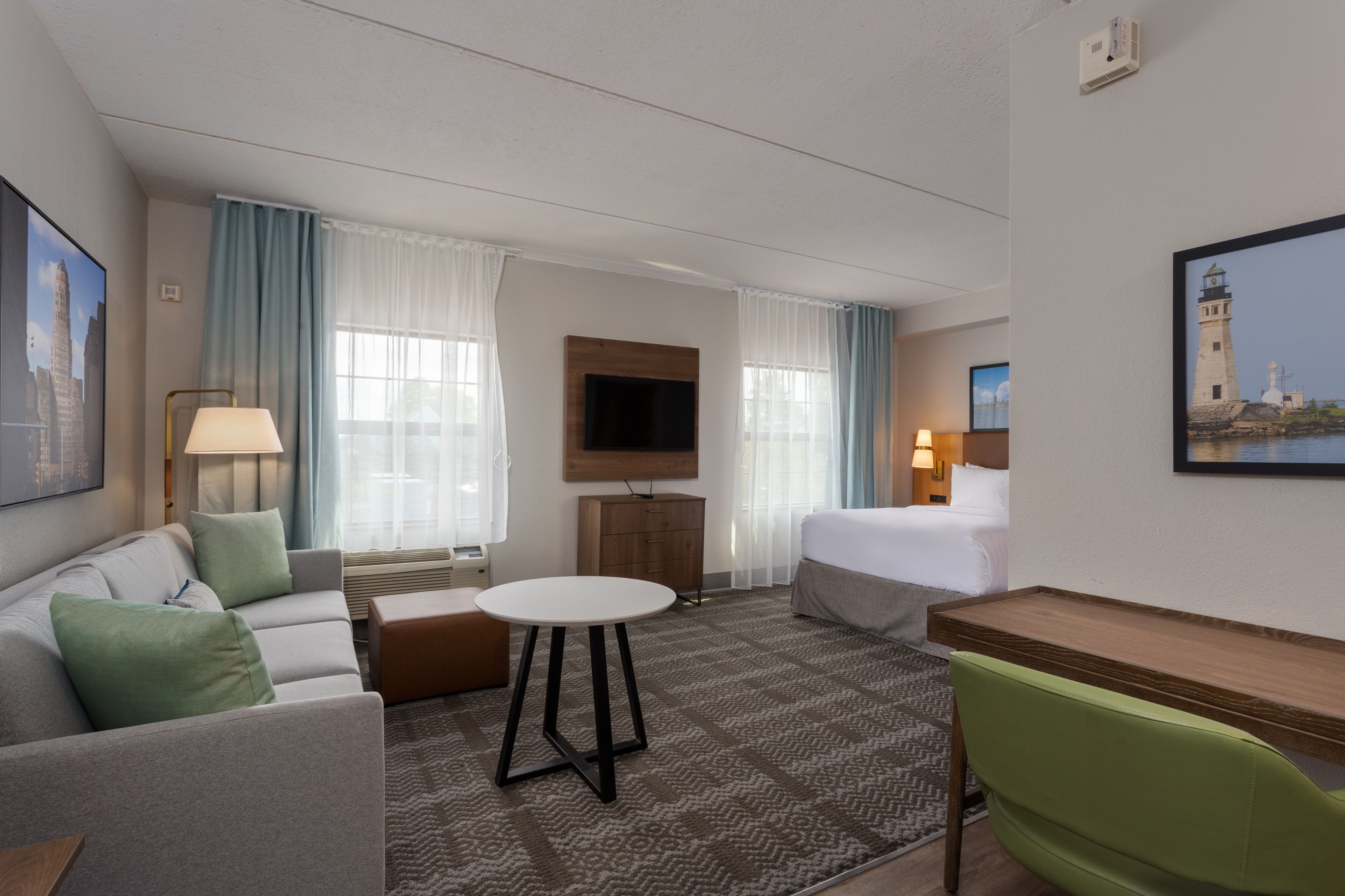 image Studio suite with sofa seating area, desk, and natural light.