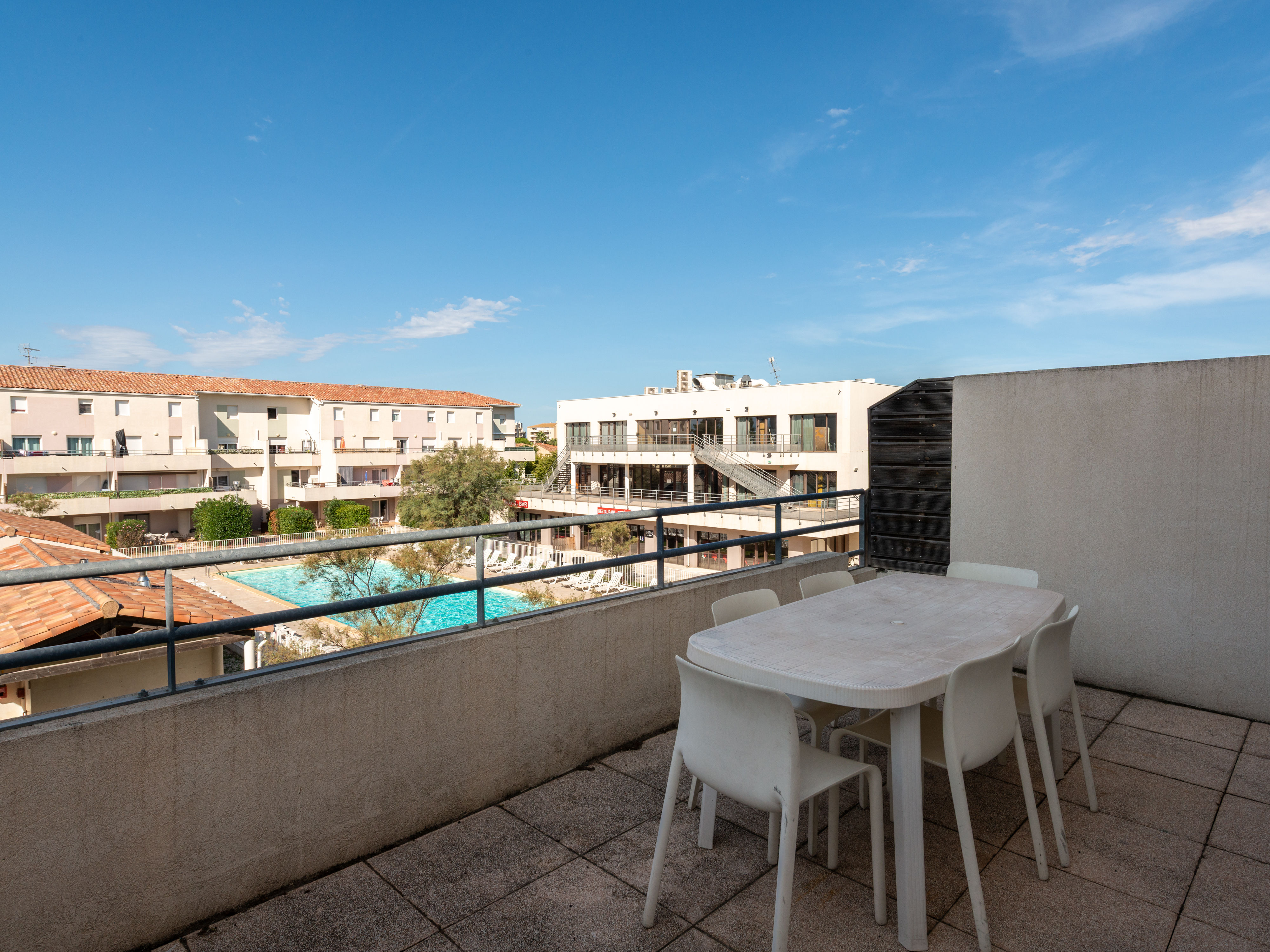 image Step out onto the private balcony with outdoor seating and a direct view of the heated pool