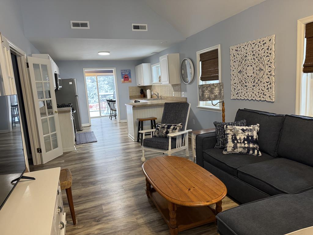 image Open living area with plush sectional sofa, Smart TV, and central A/C for after a day at the beach