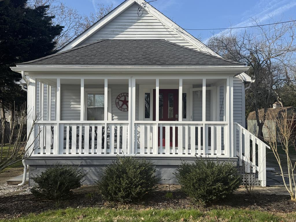 image White-sided cottage with wraparound porch and front steps — your home base one mile from the Cape May beaches.