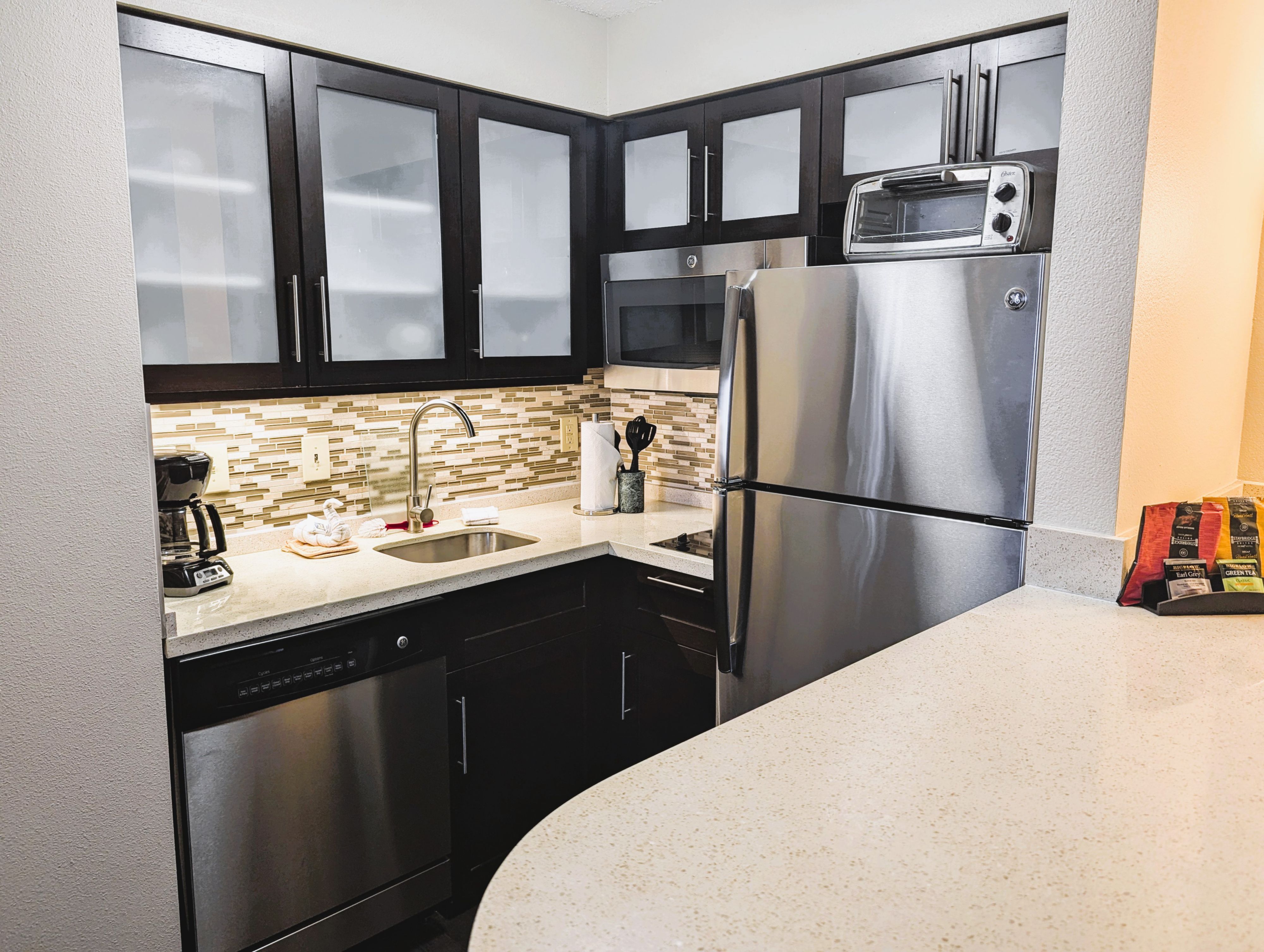 image Well-appointed kitchen with contemporary cabinets and full appliances.
