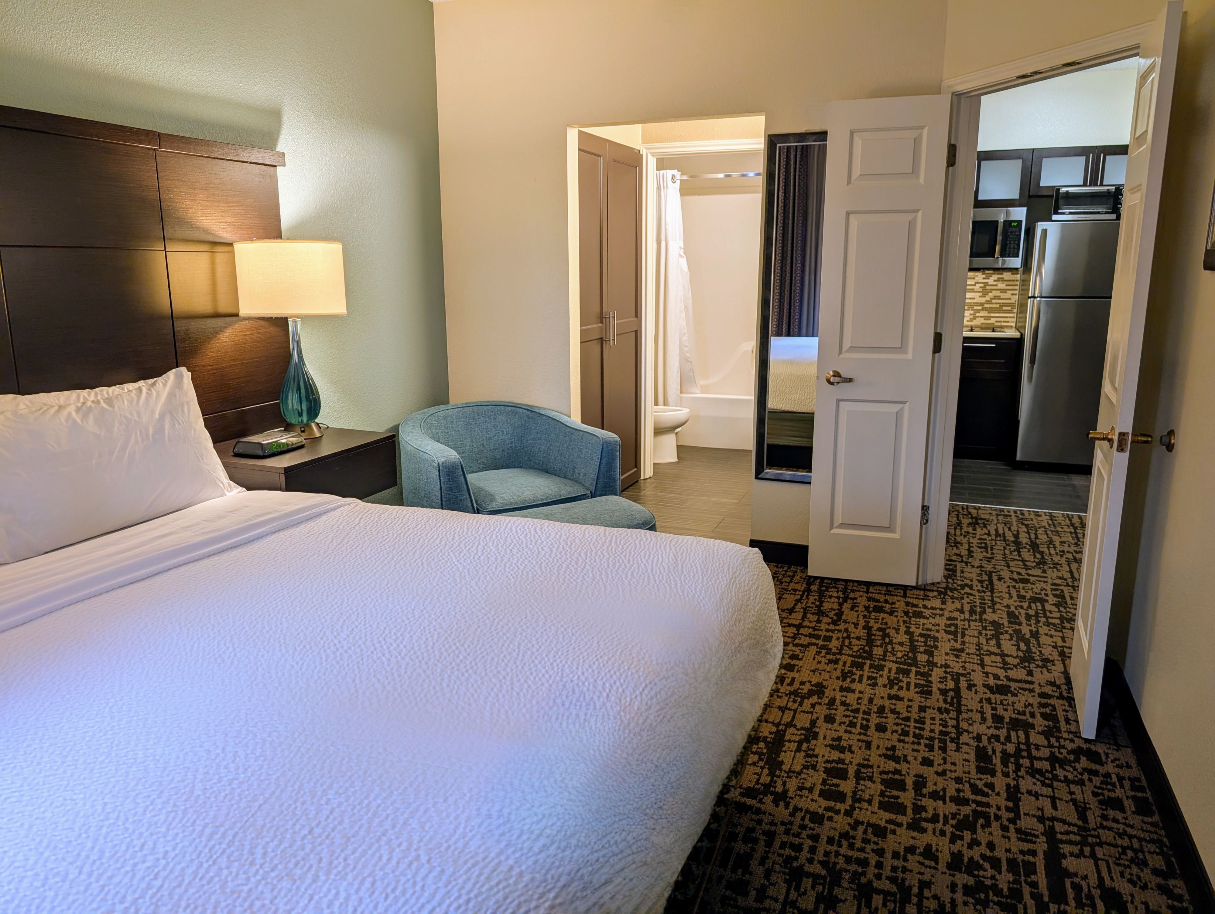 image Double queen bedroom with comfortable seating and inviting décor.