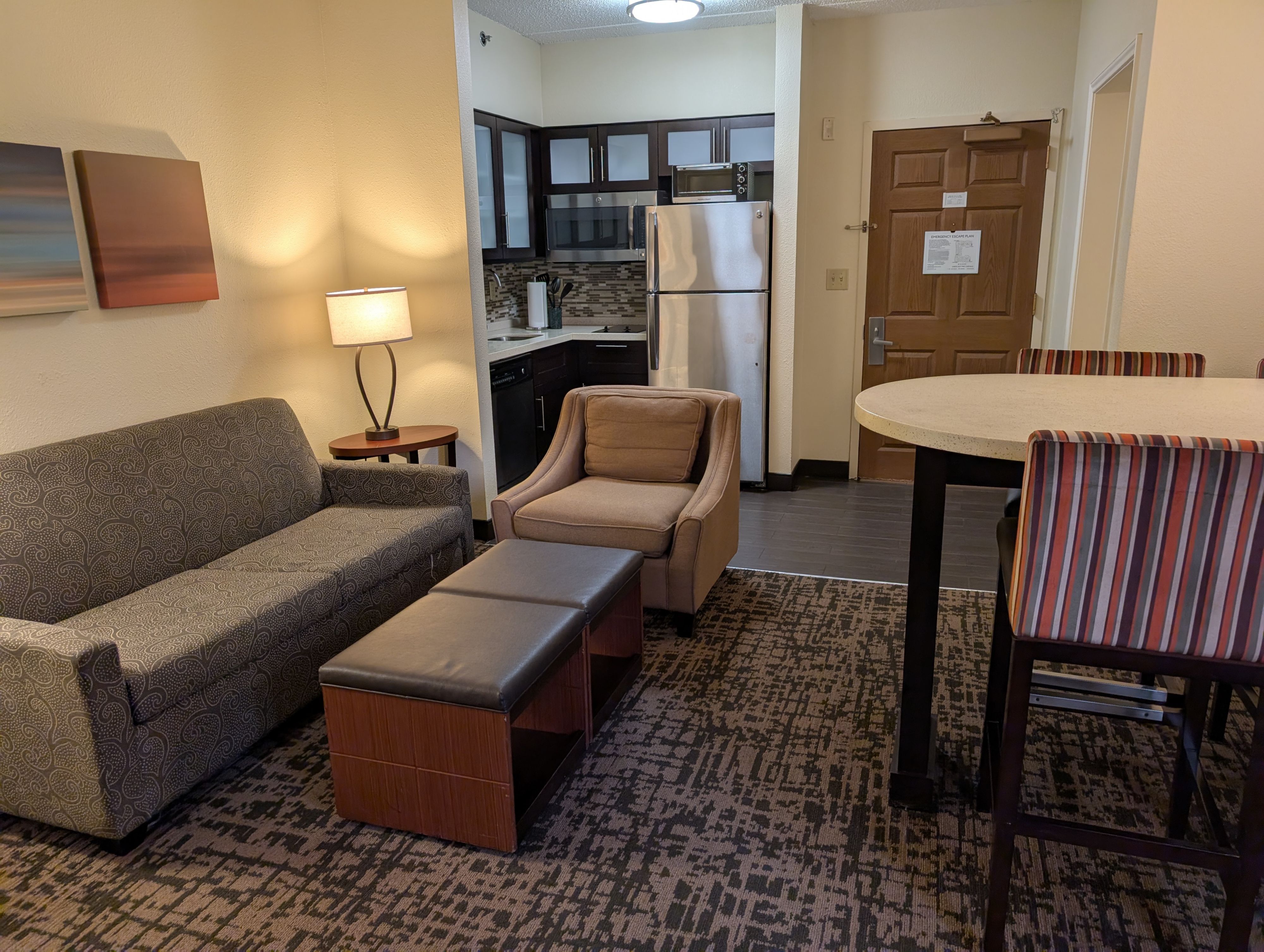 image Spacious living area with sofa seating and dining table.