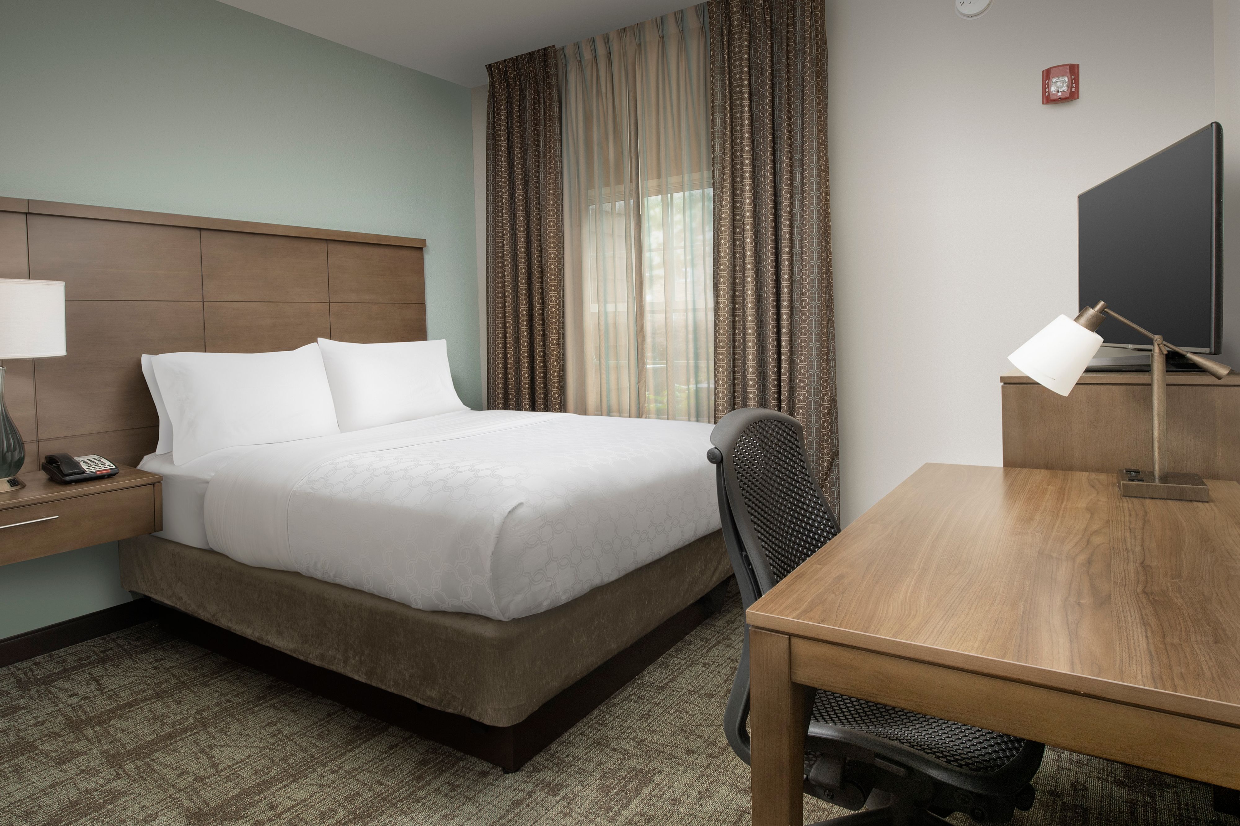 image Comfortable bedroom with plush king bed and restful decor.