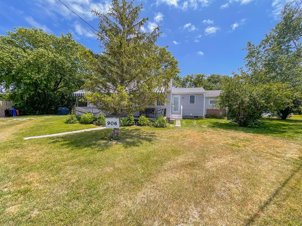 image Pull into the driveway and take in the wide front yard — mature trees and a covered porch welcome you
