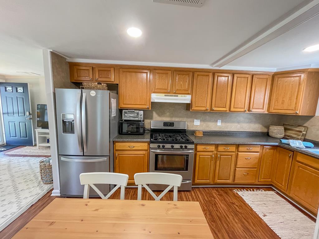 image Dining table seats 6 — coffee maker and blender on the counter ready for morning starts