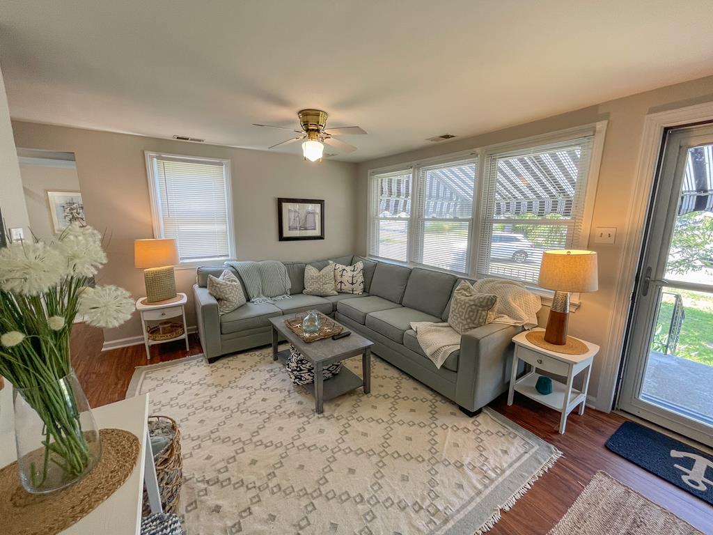 image Sectional sofa and flat screen TV — the living area also has a washer/dryer closet off to the side