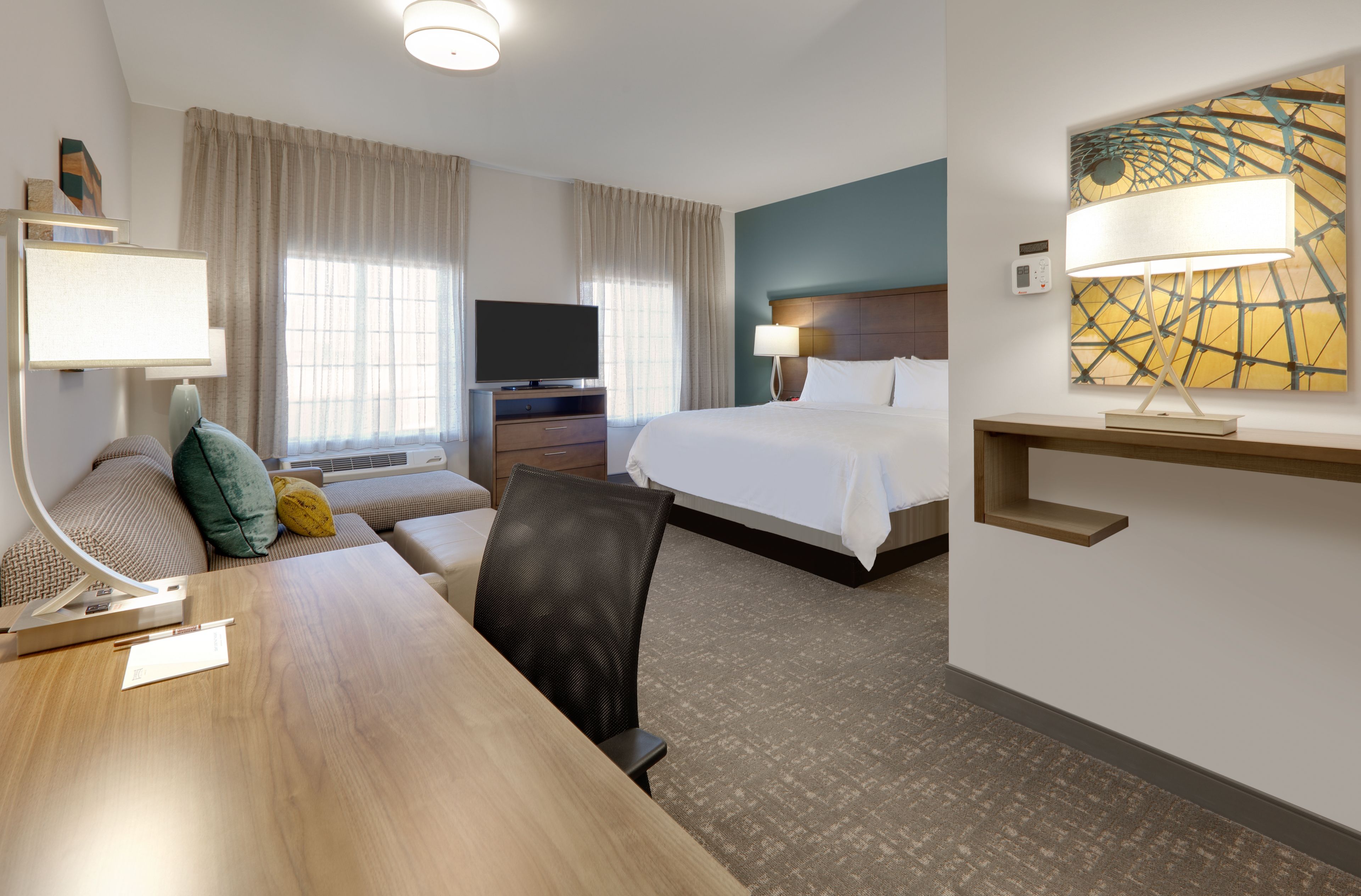 image Inviting king bedroom featuring a plush bed and elegant decor.