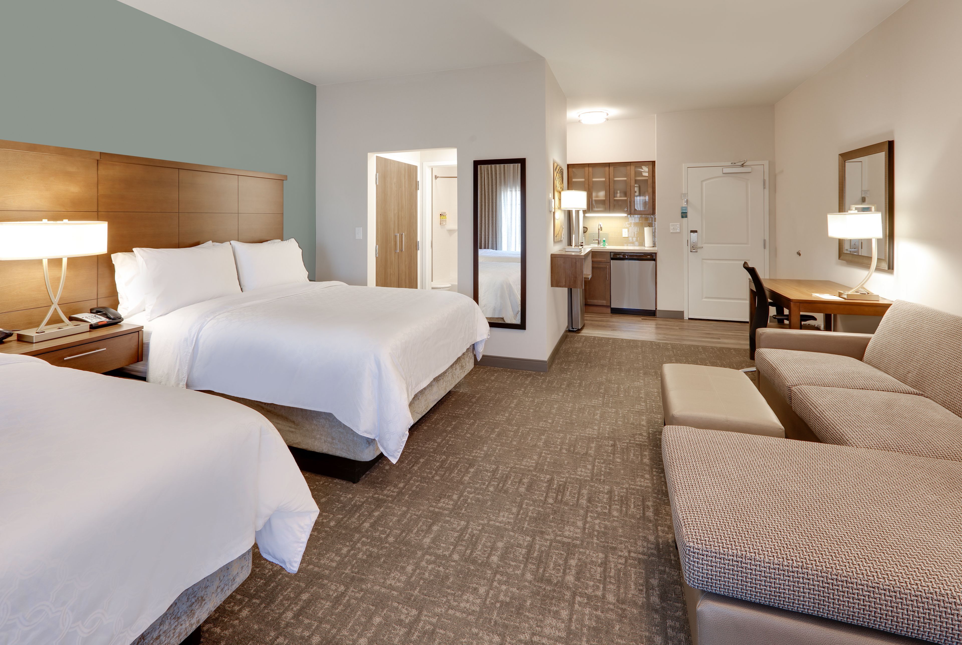 image Elegant suite with kitchen and modern furnishings throughout.