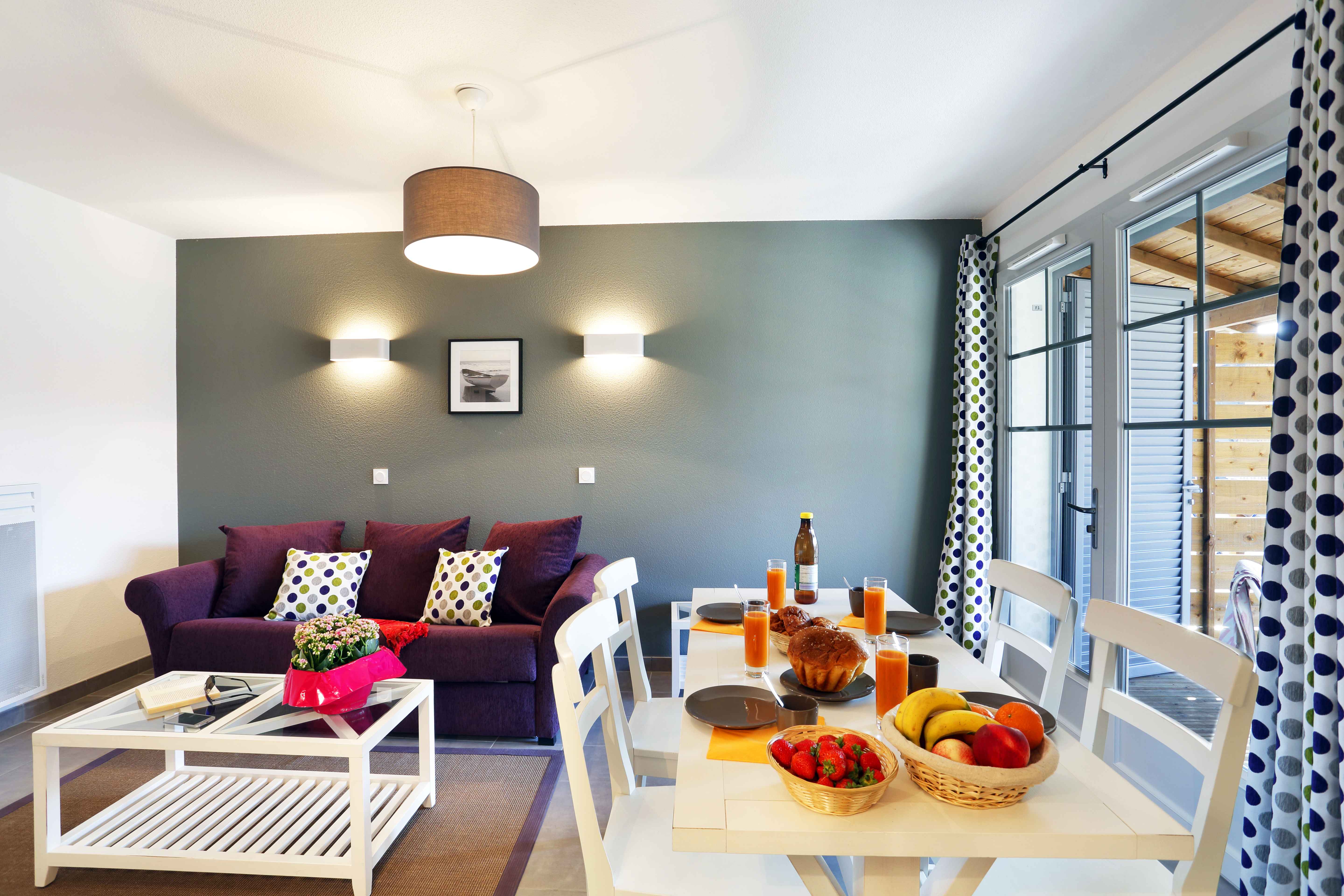 image Open-plan living and dining area with seating for the whole group — sofa converts to a double bed for two more.