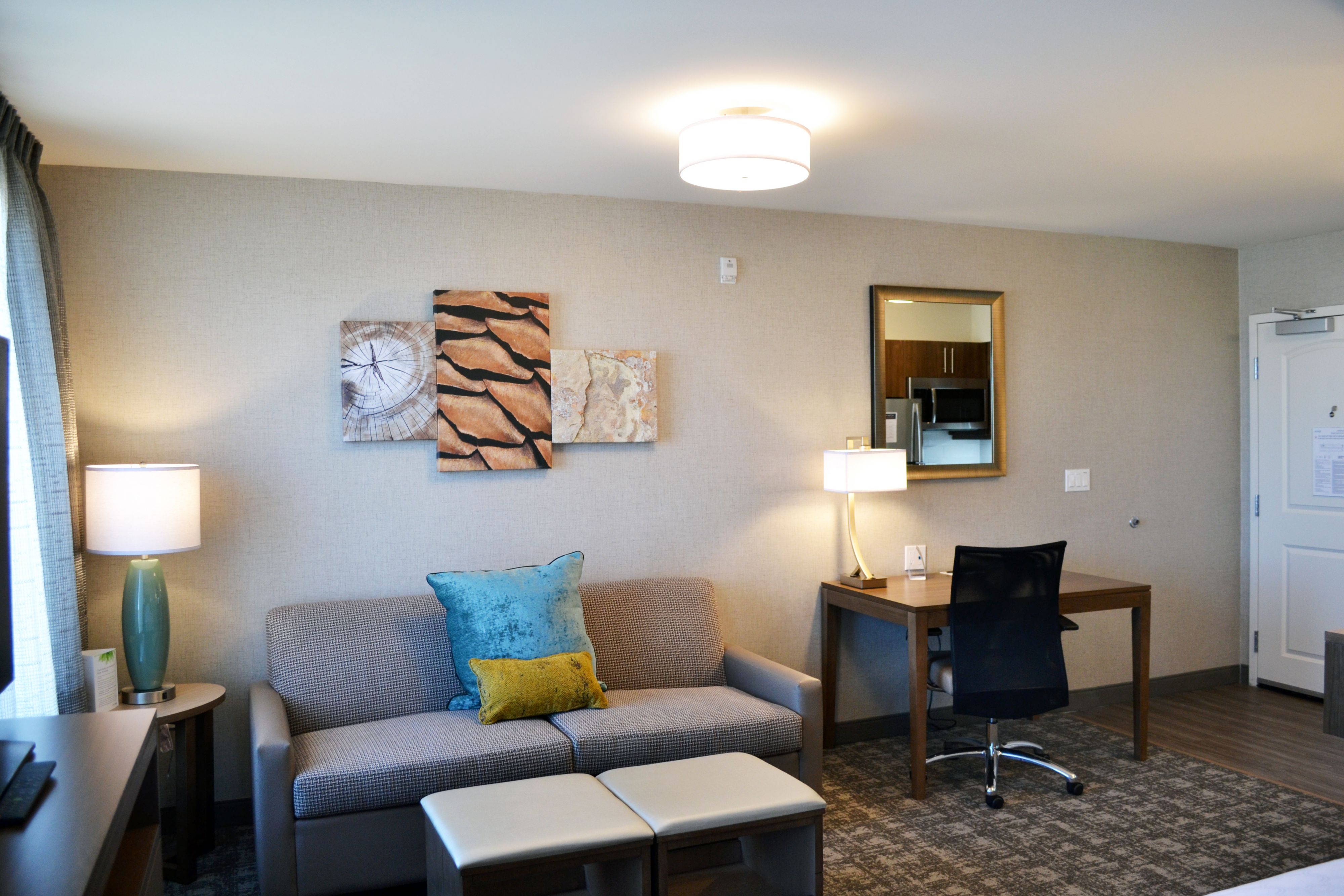 image Comfortable living area with decorative accents and dedicated workspace.