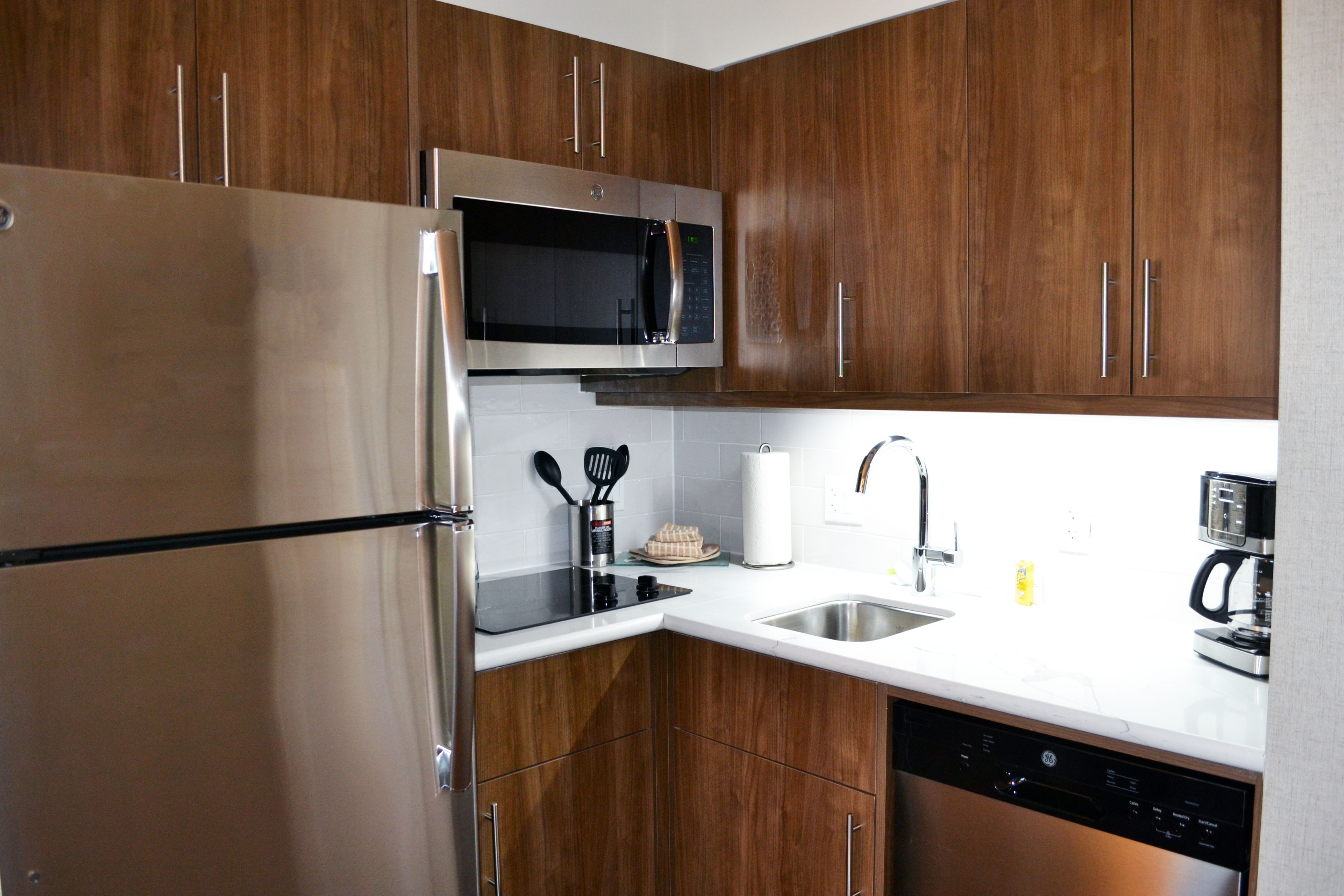image Functional kitchen equipped with essential appliances and prep space.