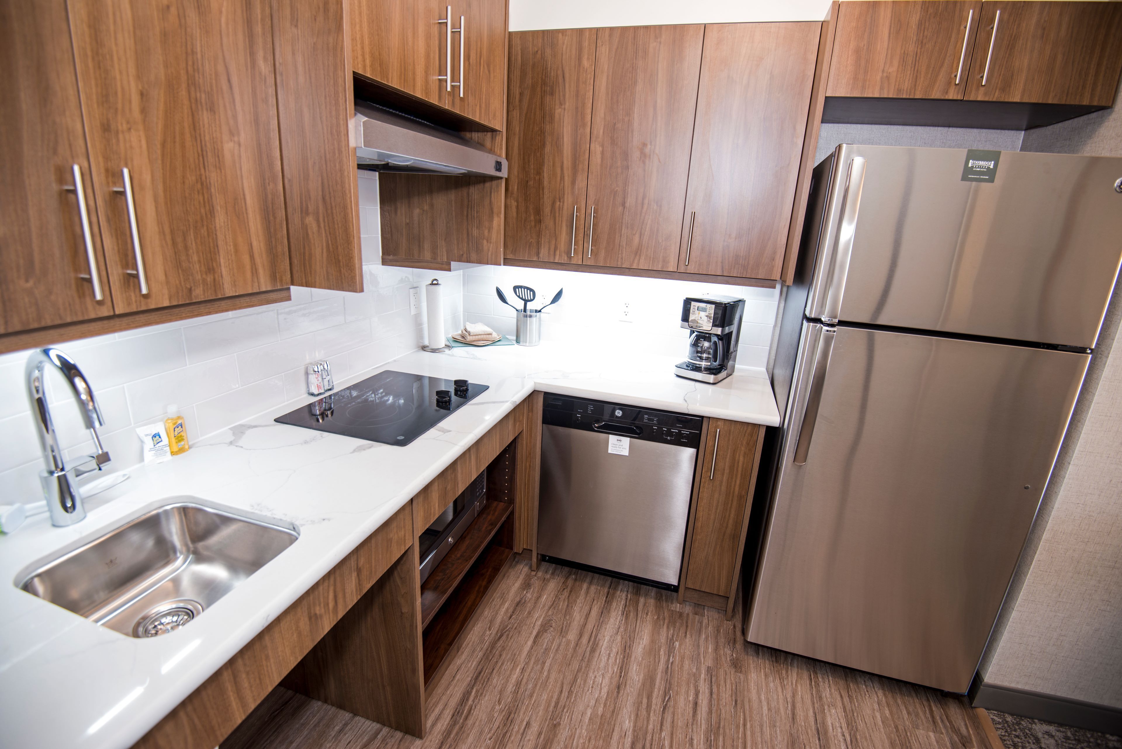 image Fully equipped kitchen with modern appliances and sleek countertops.