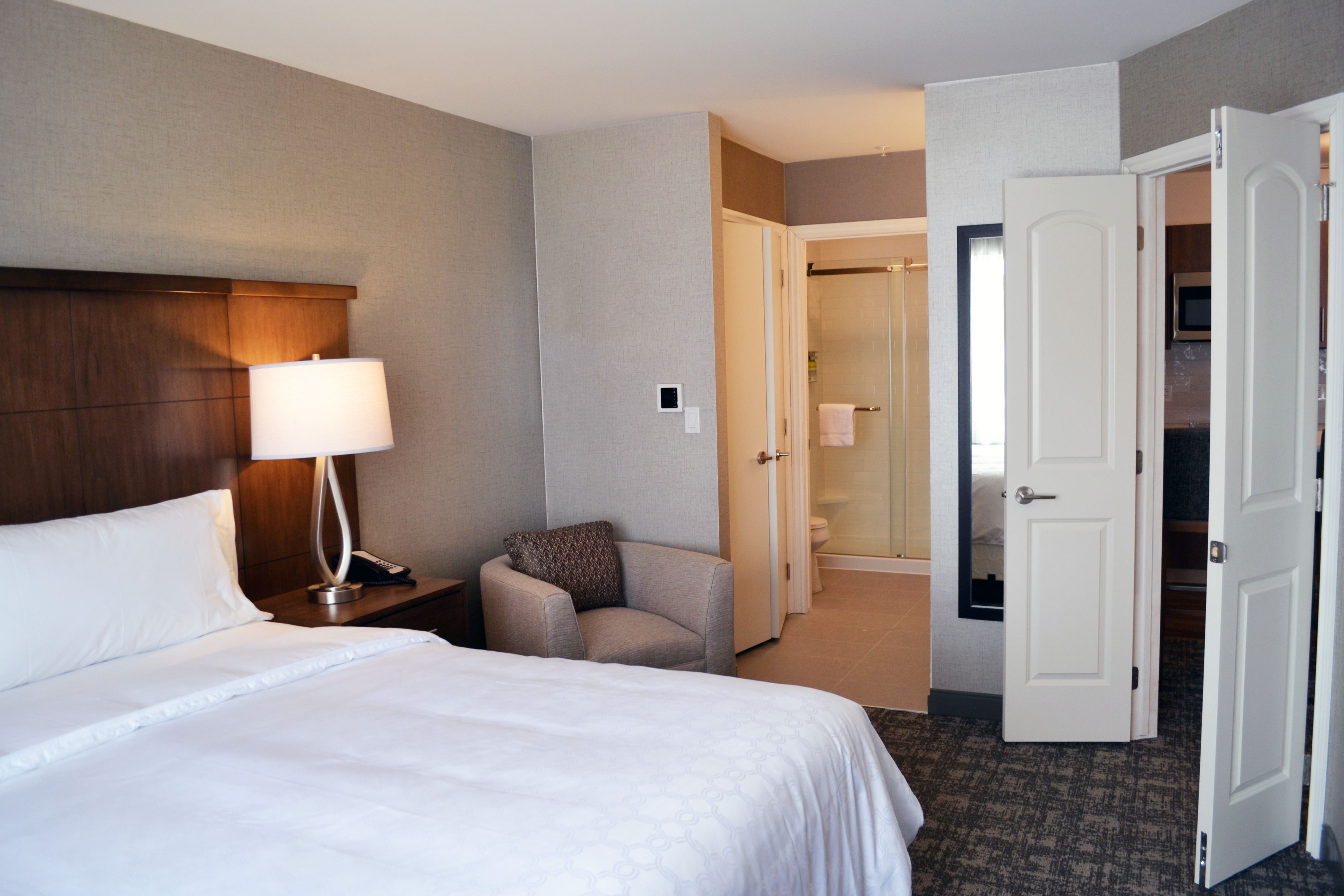 image Cozy bedroom with a comfortable bed and warm lighting.