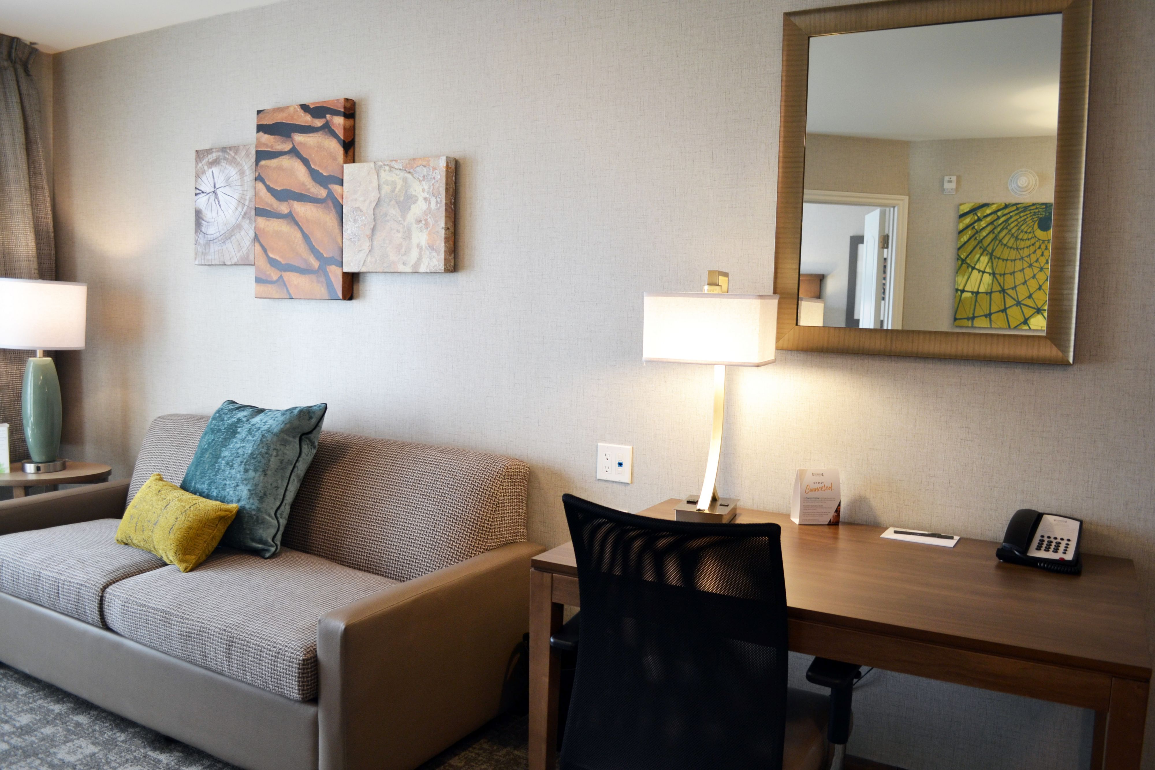 image Living area with sofa, desk, and ambient lighting.