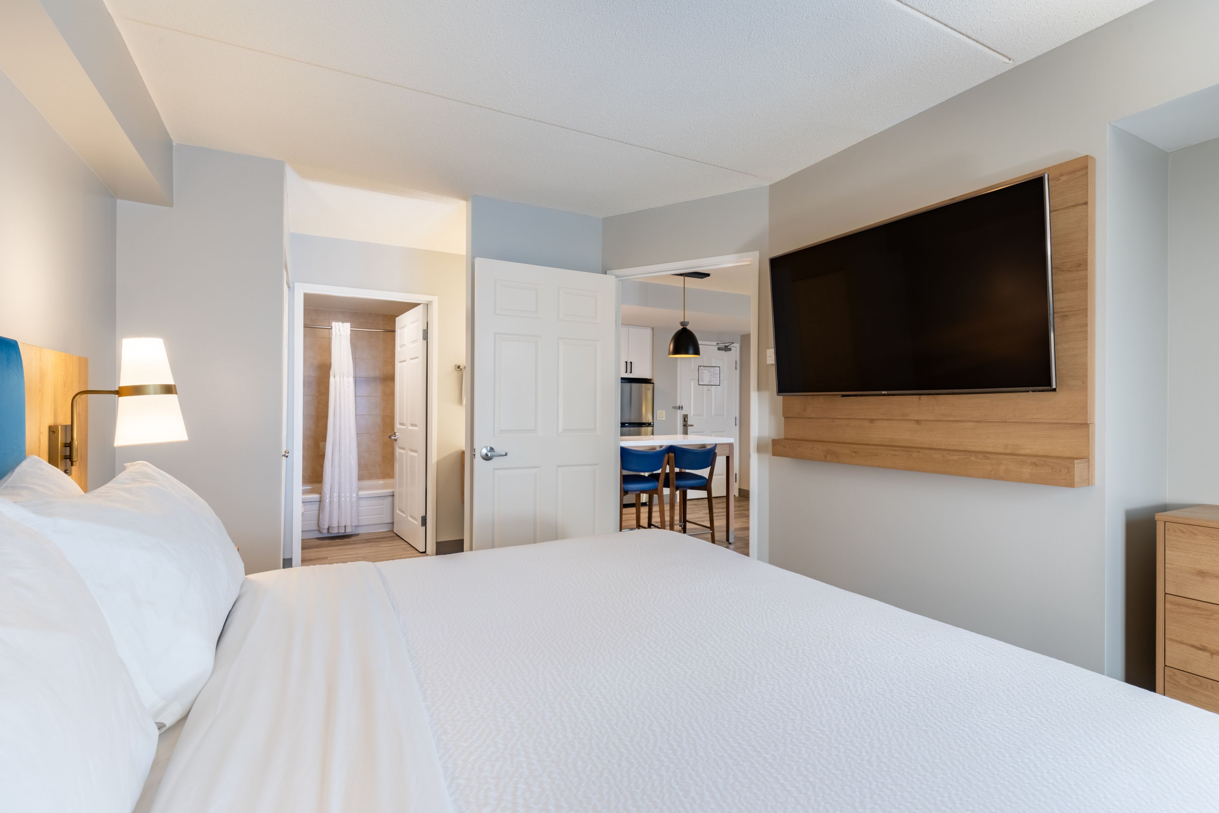 image Accessible king bedroom with flat-screen TV and open layout.