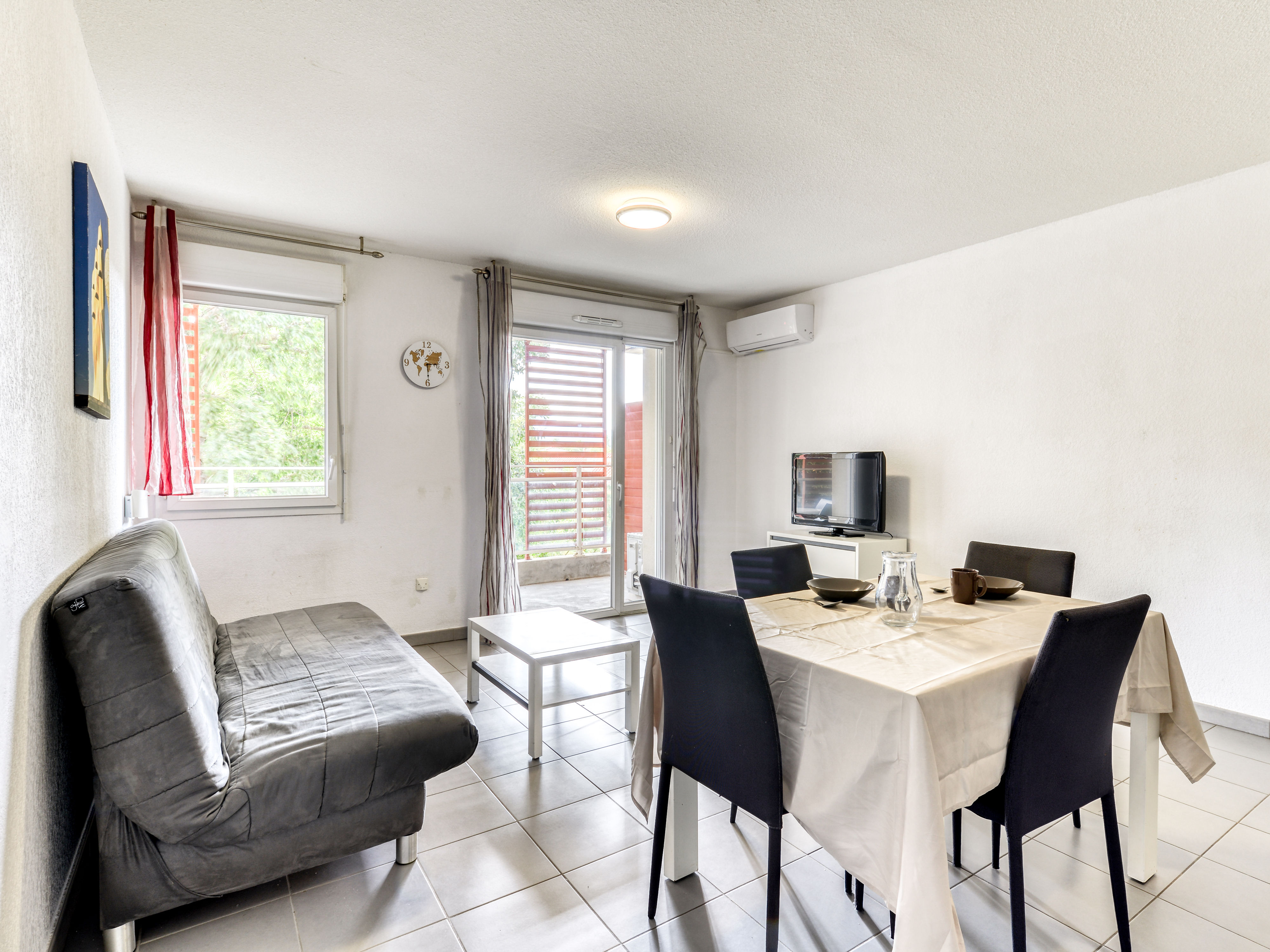image Settle into the living area with a double sofa bed and flat-screen TV — the pool is just outside
