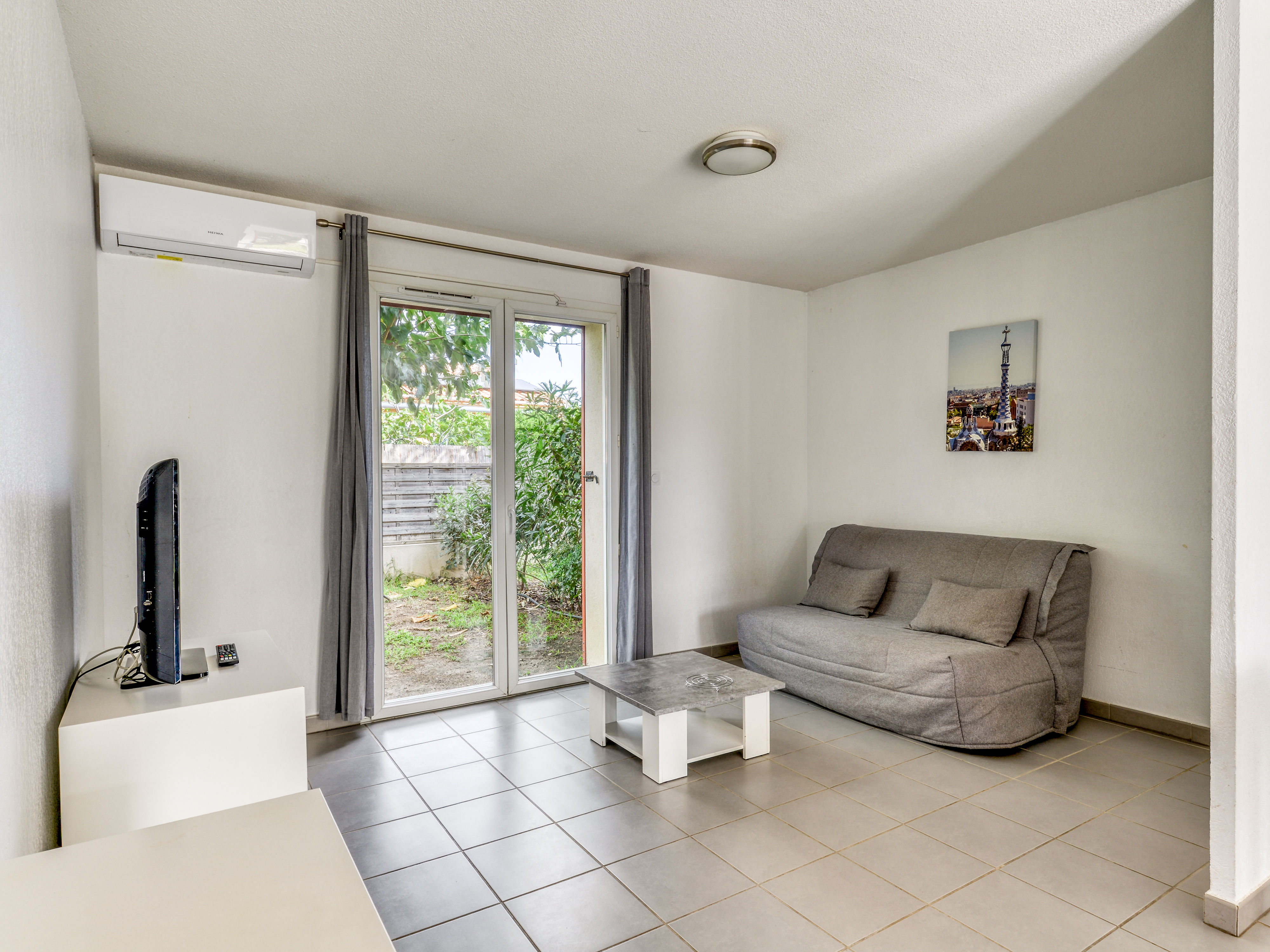 image Living area with a double sofa bed and flat-screen TV — sleeps two for movie nights