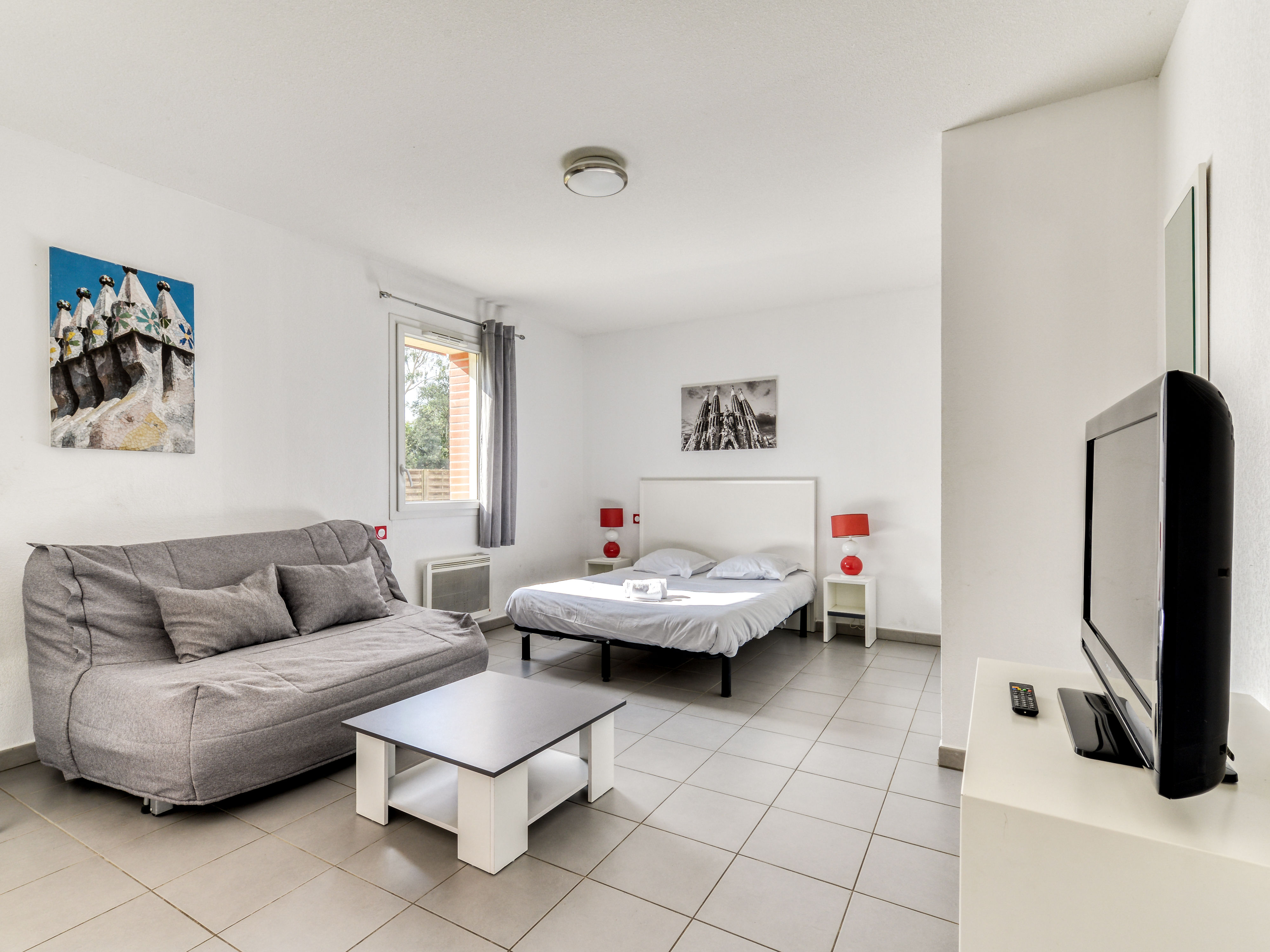 image Living area with a grey sofa bed and flat-screen TV — sleeps four between the sofa bed and clic-clac