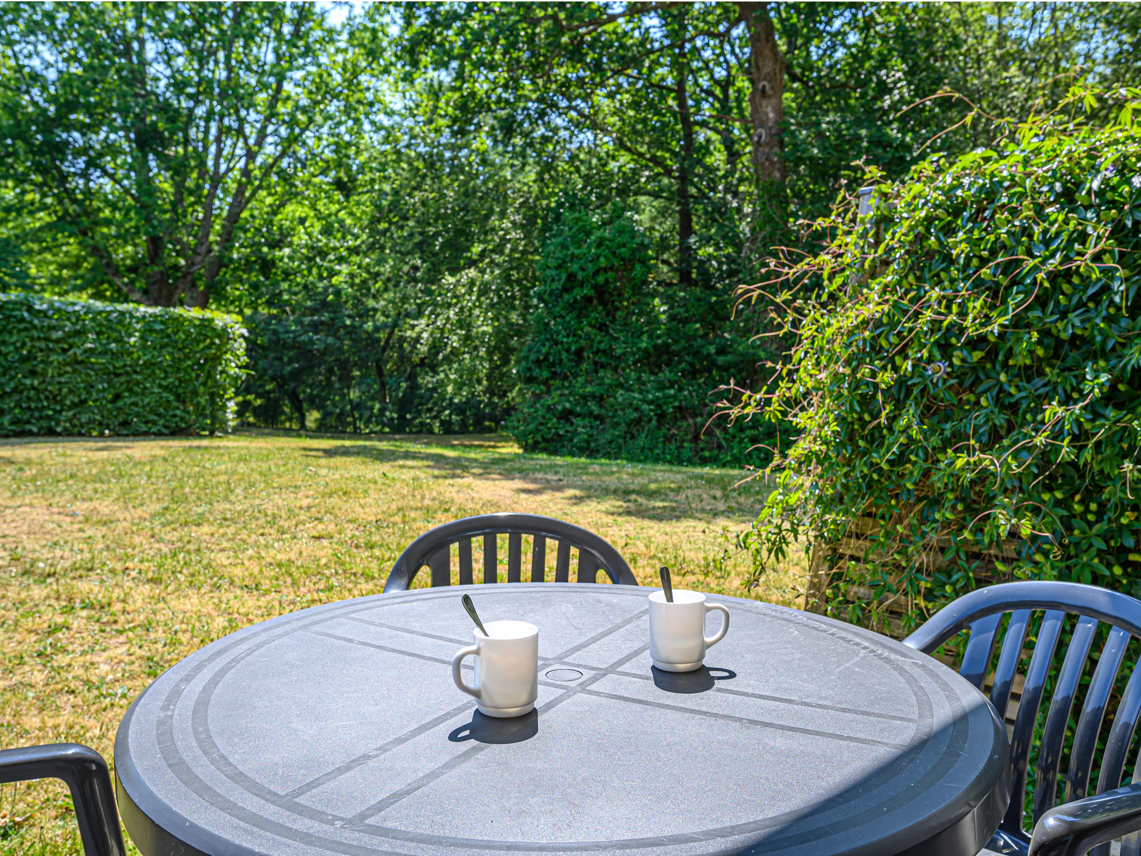 image Picture sunny afternoons at the round table, drinks in hand, under the dappled shade of the trees.