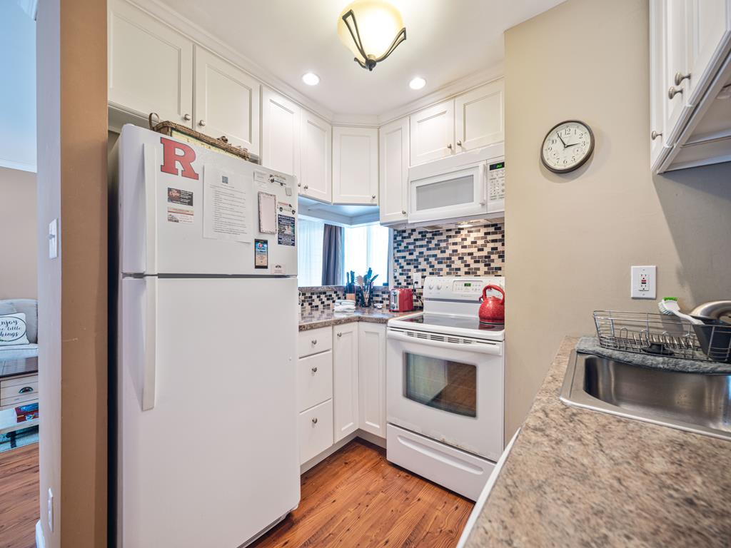 image A cozy corner of the kitchen awaits your culinary adventures, complete with beautiful finishes and ample sunlight.
