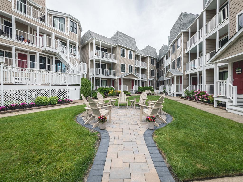image Gather around the fire pit for cozy evenings with friends in this inviting courtyard.