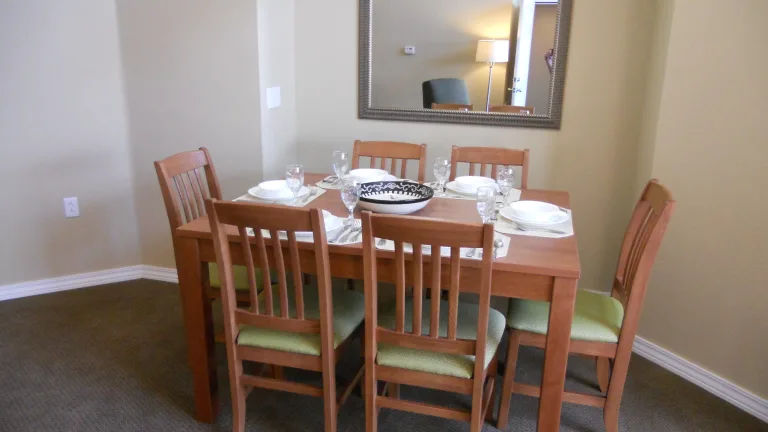 image Dining table set for six with elegant dinnerware.