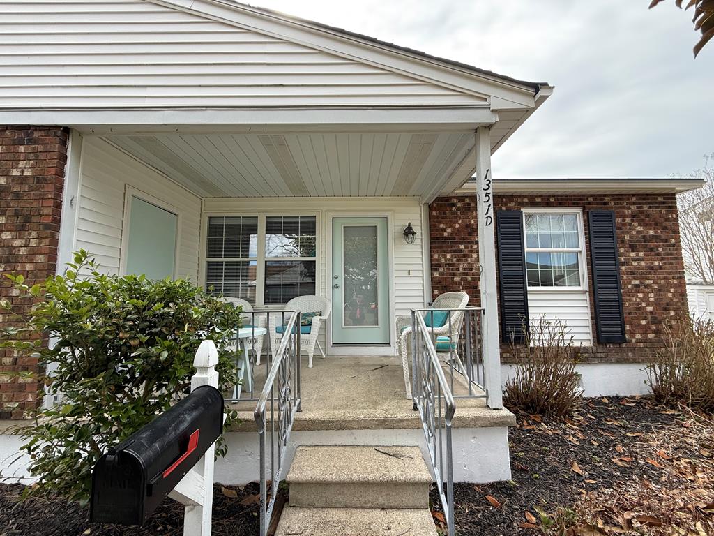 image Charming entryway with seating, perfect for relaxing outside in a welcoming neighborhood.