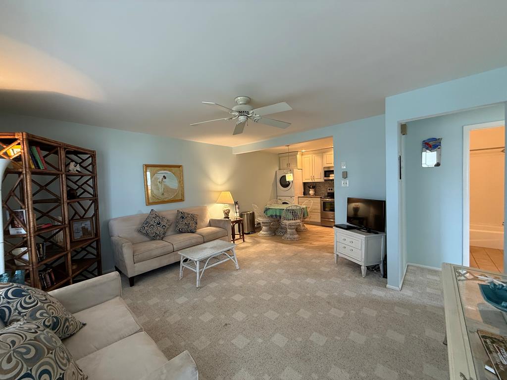 image Charming living room with cozy sofa, stylish decor, and open kitchen view.