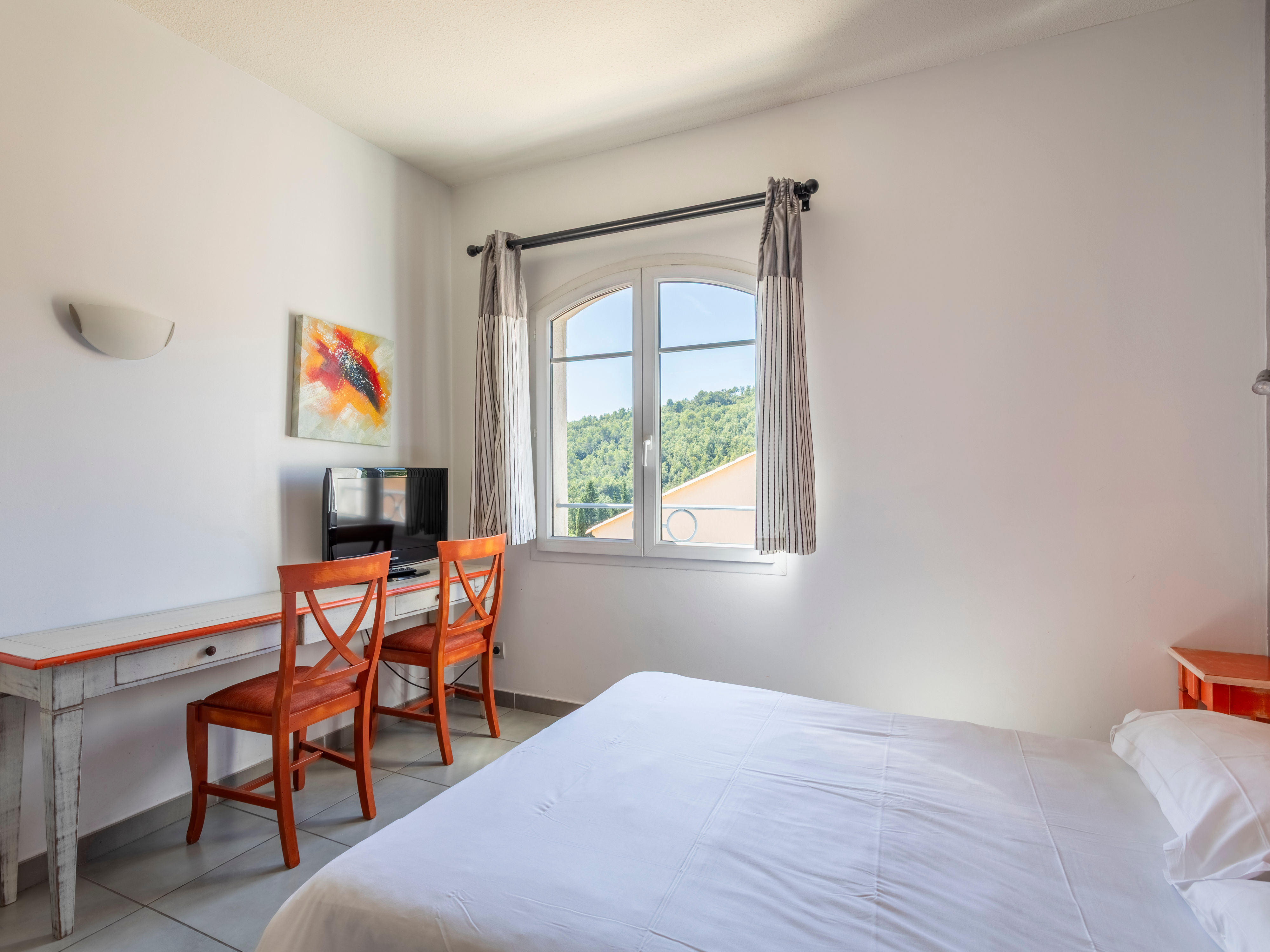 image Light-filled room with two single beds, desk space, and air conditioning — breakfast buffet available downstairs