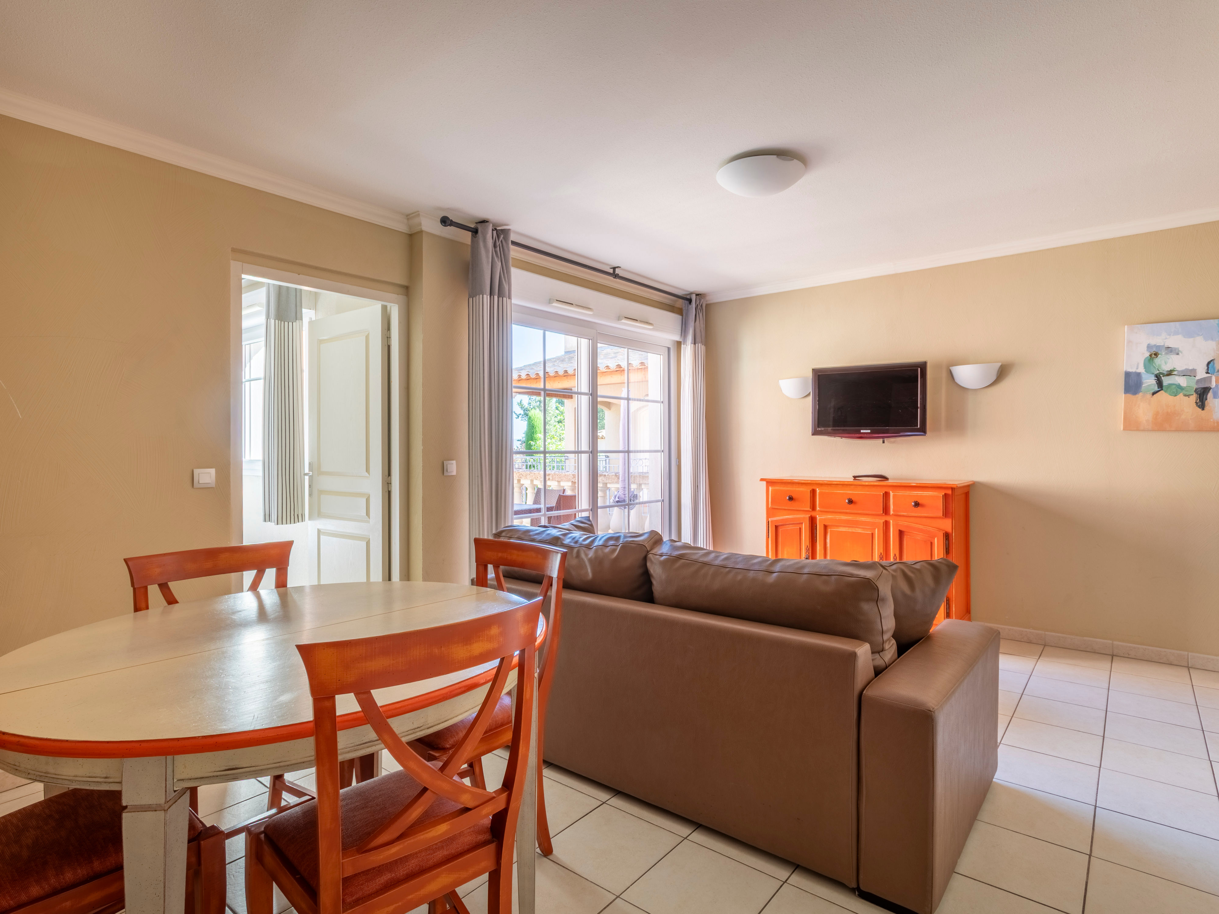 image Open-plan living area with sofa bed for two, direct access to the balcony, and natural light throughout