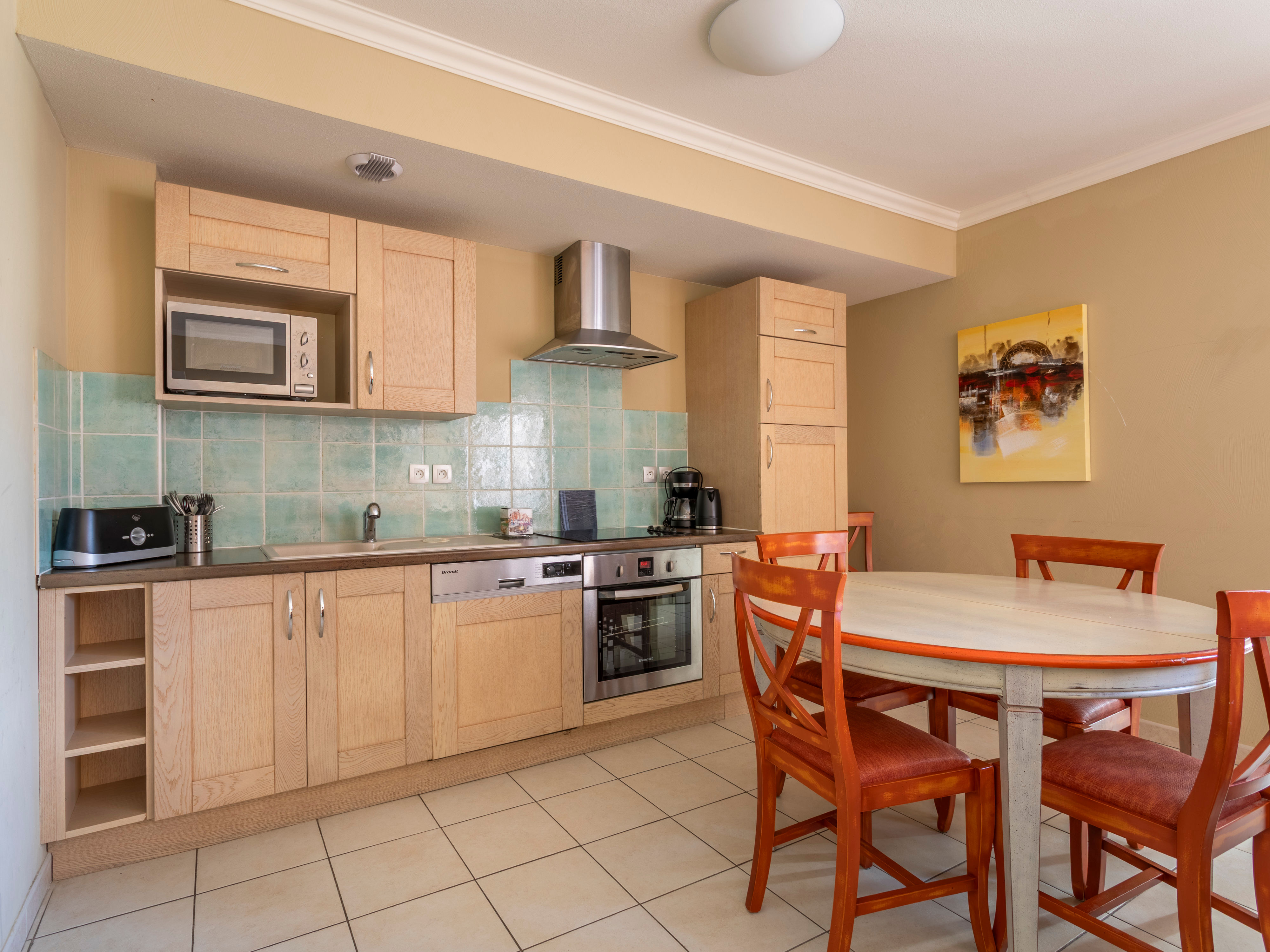 image The kitchen comes fully loaded — ceramic hob, dishwasher, microwave grill, filter coffee maker, and full-size fridge