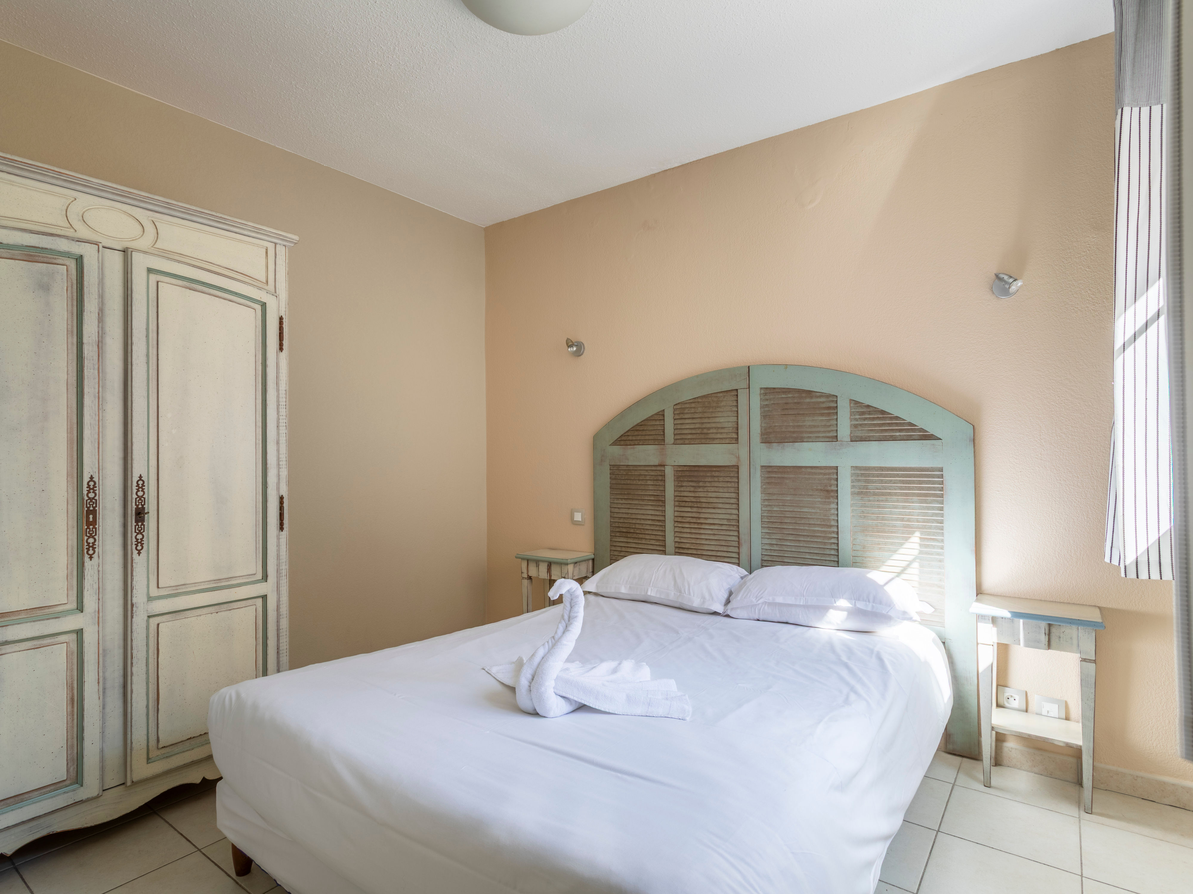 image Bedroom 1 with double bed and individual air conditioning unit — blackout curtains included