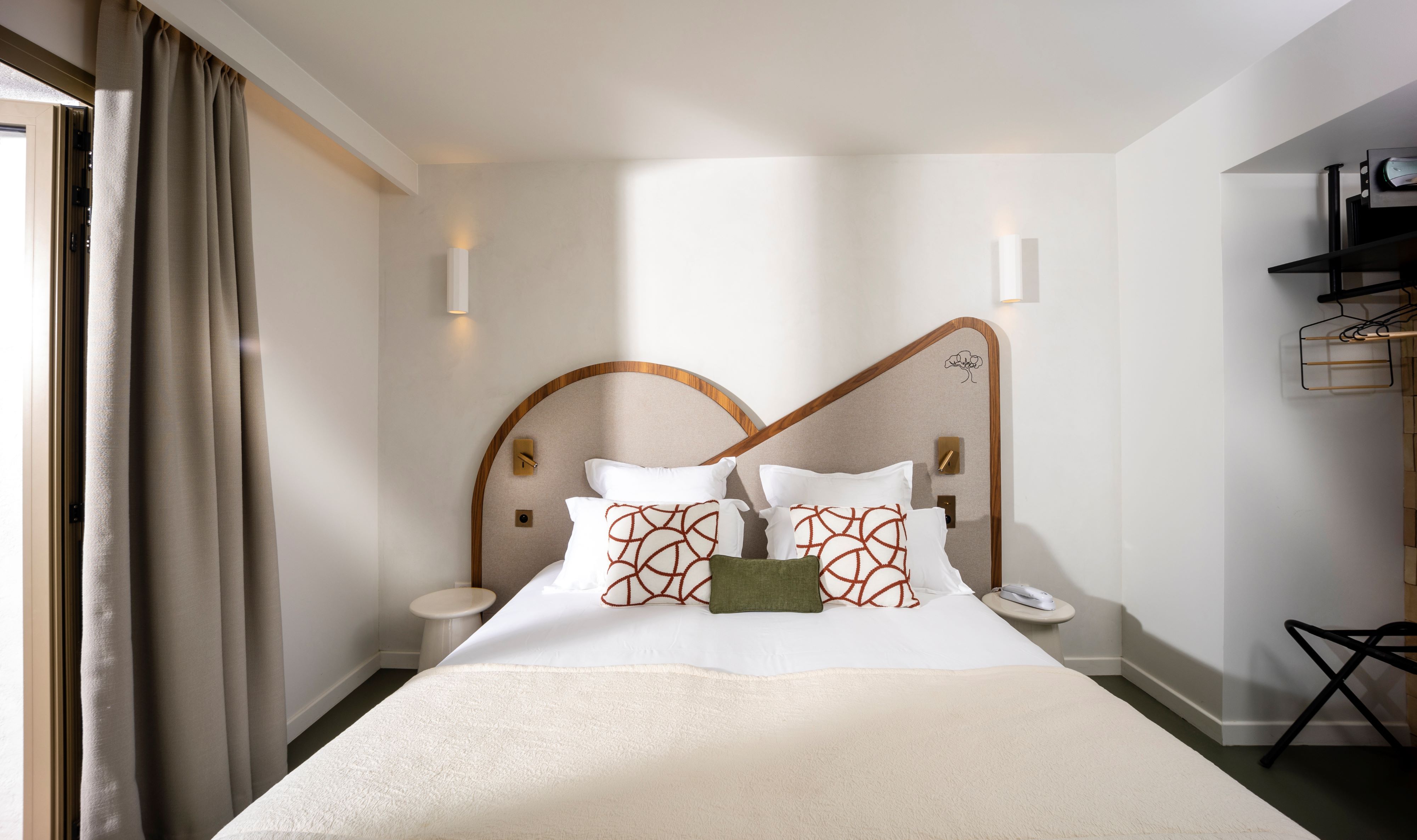 image Cream bedding and a plush throw, with natural light streaming in from the terrace door