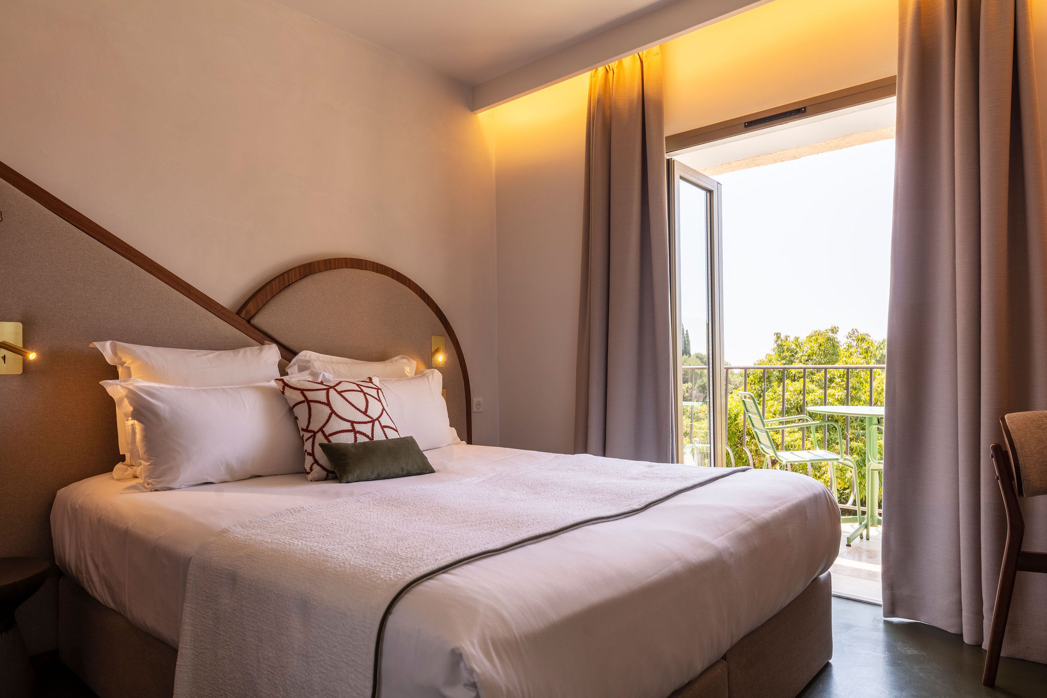 image King bed with a fabric headboard and park-view glass door — step-free access throughout